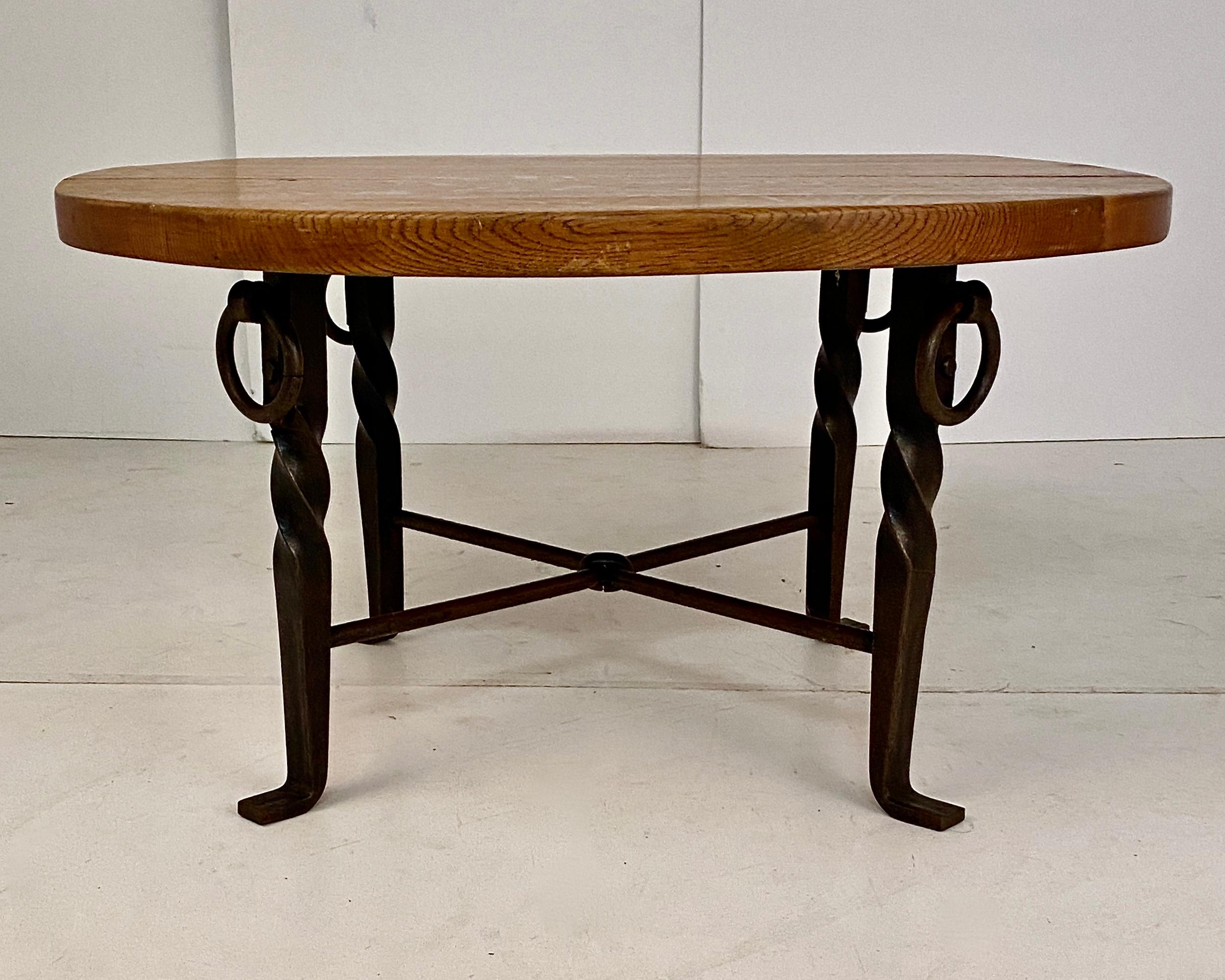Very fine quality table featuring an iron ring stretcher and a heavy oak top. Lovely patina and color. Just slightly off round , 31.5