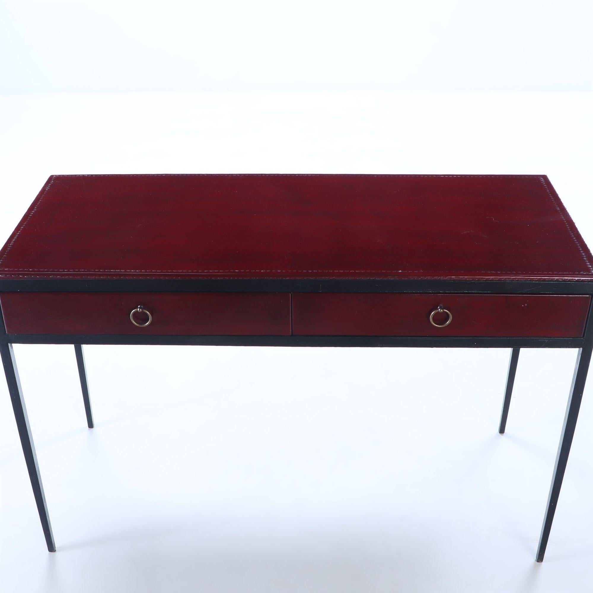 Mid-Century Modern Iron and red leather writing desk with two drawers, manner of Jean-Micheal Frank For Sale
