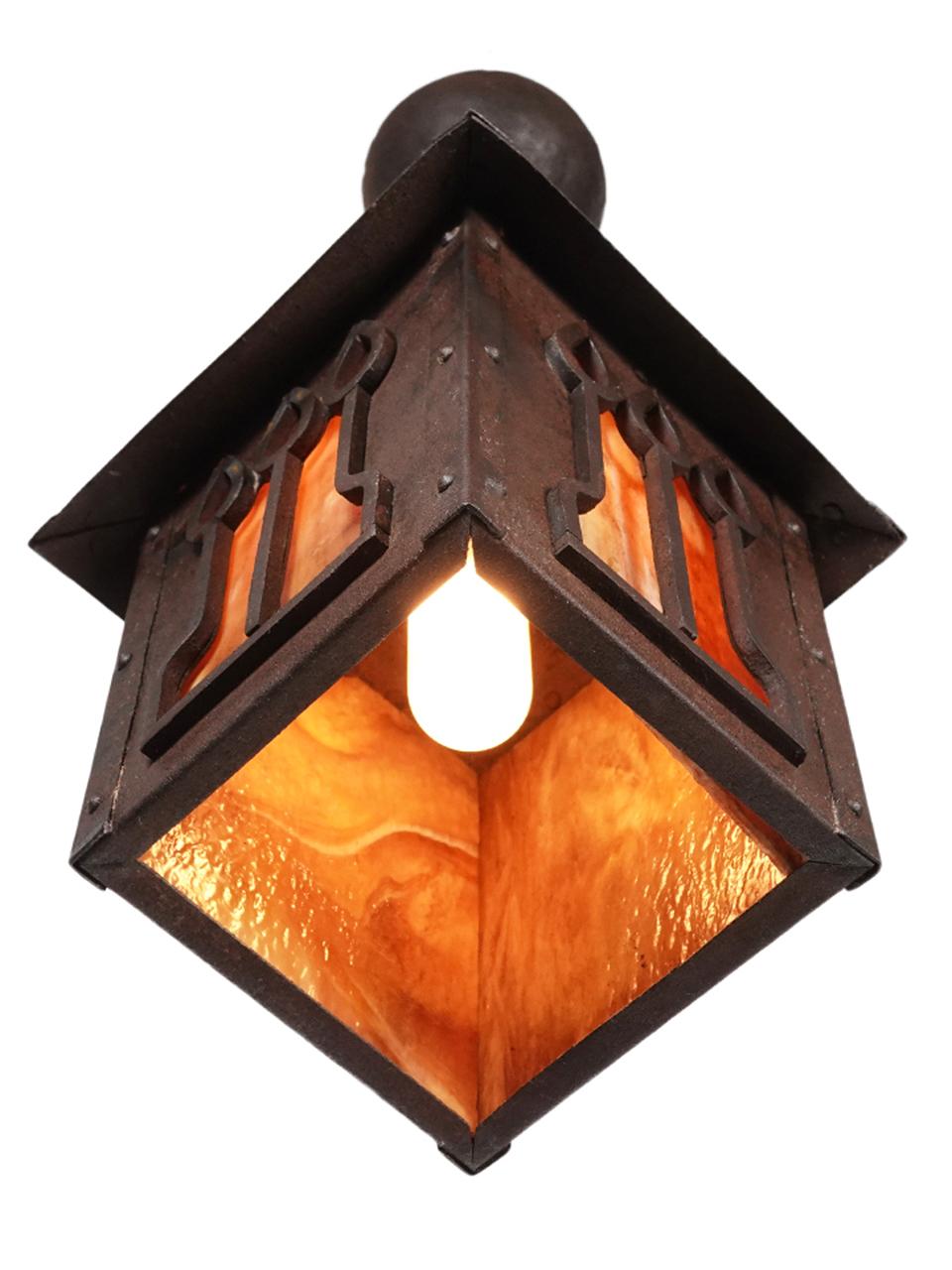 This is a very high style and earl Arts & Crafts Lantern. The metal is iron and handmade. The glass is a variegated amber glass. Its unsigned but could be an important maker.