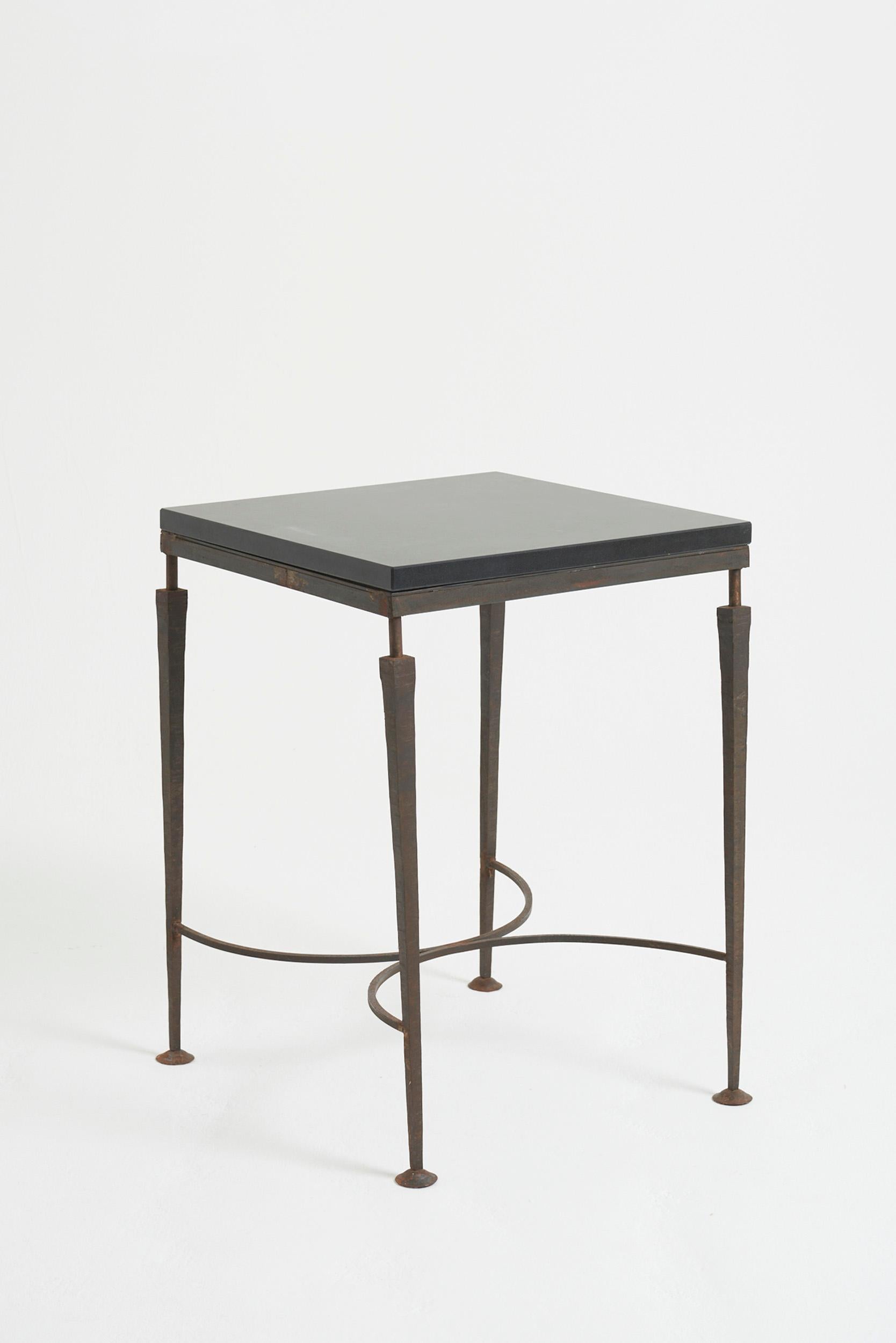 A wrought iron and black stone top square table
France, second half of the 20th Century