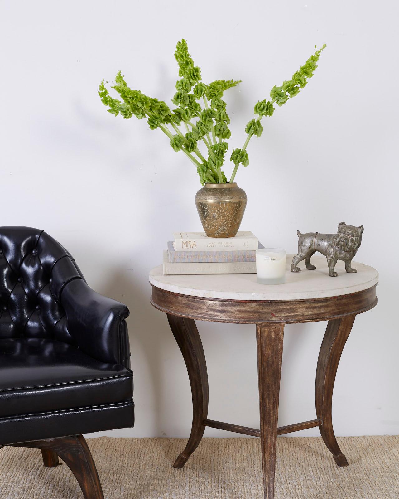 Attractive center table or drink's table constructed from iron with a lovely painted finish. Features a round, natural stone top with a matte, unhoned finish. Made by a foundry in Los Angeles, CA. Supported by three stylish saber legs in an hour