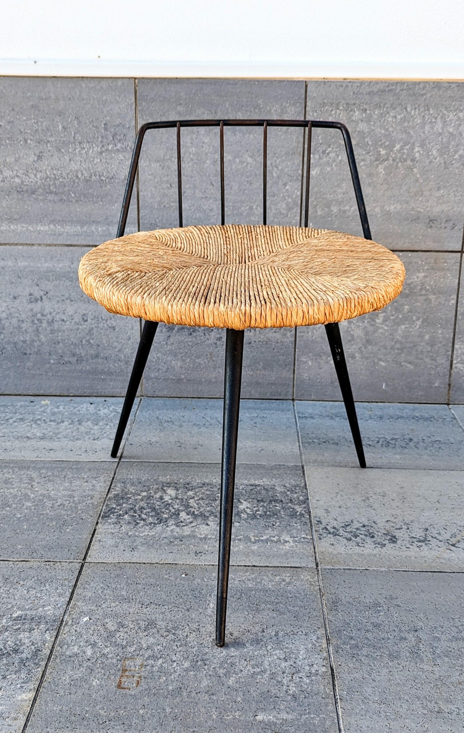 Rare and beautiful iron and straw stool manufactured in France in 1960s. Very decorative and practical with its three feet. Ideal for additional seating in a living room or near a fireplace.