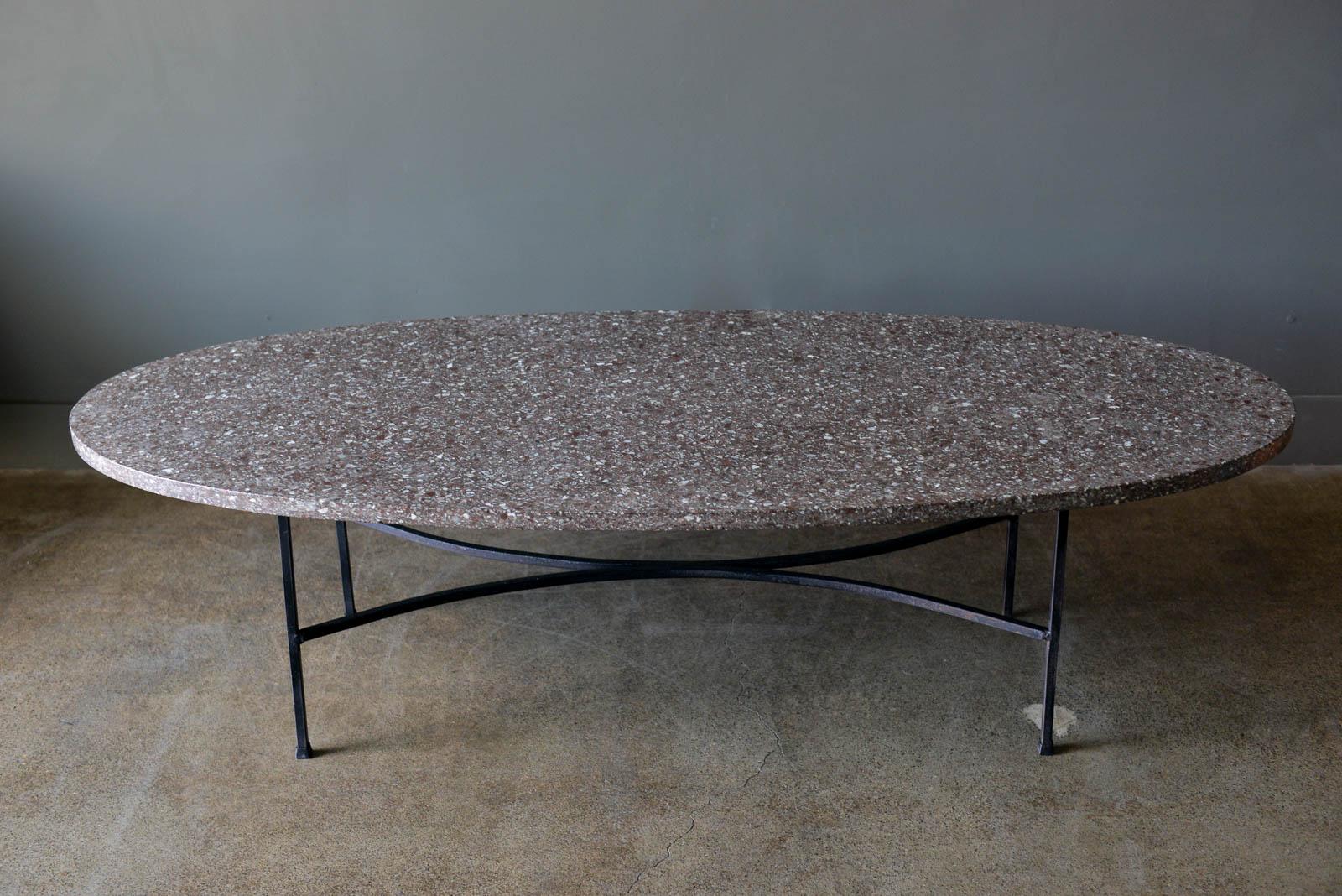 Iron and Terrazzo coffee table, ca. 1965. Beautiful original dark terrazzo with iron base. Original condition. Travertine is good with only sight wear, no cracks. Some tiny 'flea bites' on edges, however not visible but you can feel. Great oval or