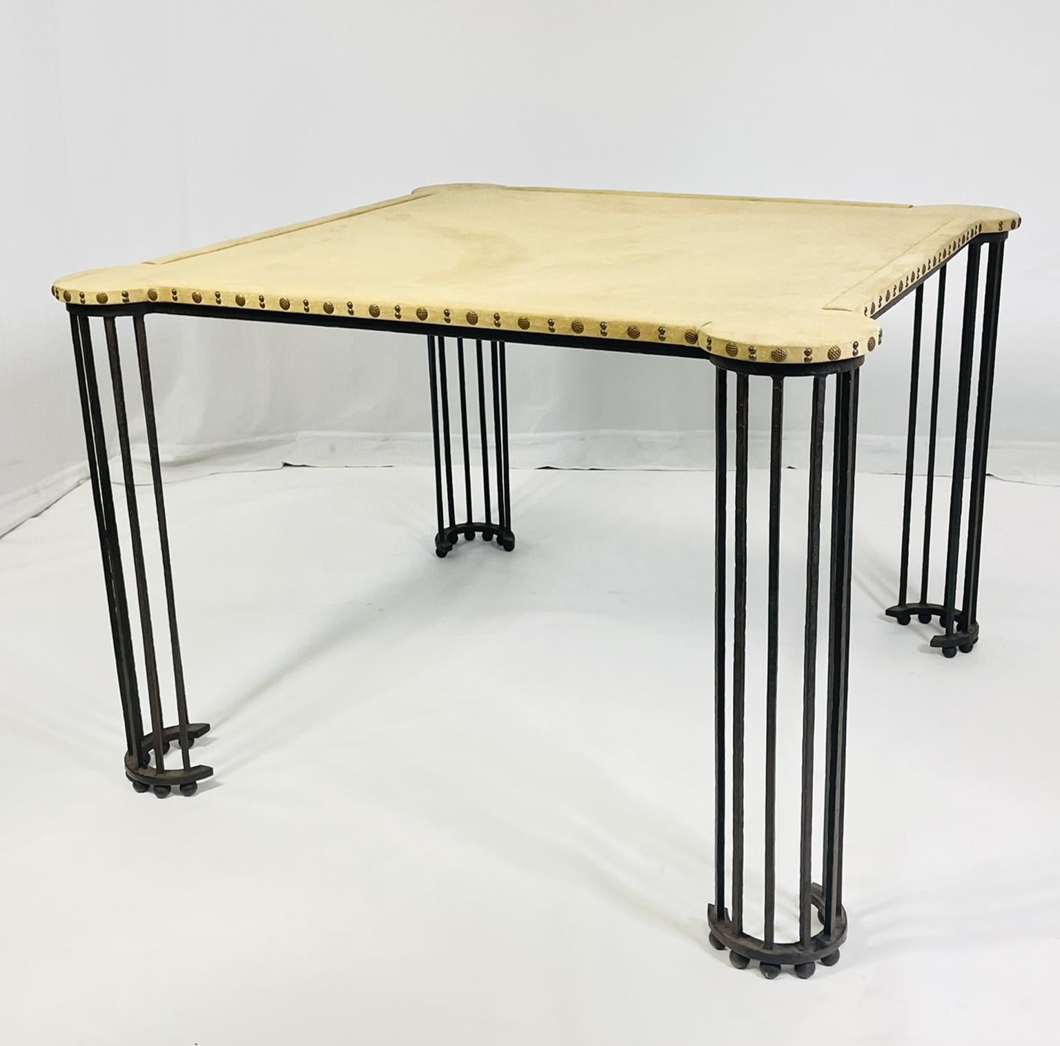 Beautiful game table designed and manufactured in the United States by Marjorie Shushan Studio.
 
The table is made in solid Iron with an aged finish, the top is upholstered in ultrasuede fabric with nail head details all around the top.
 
The table
