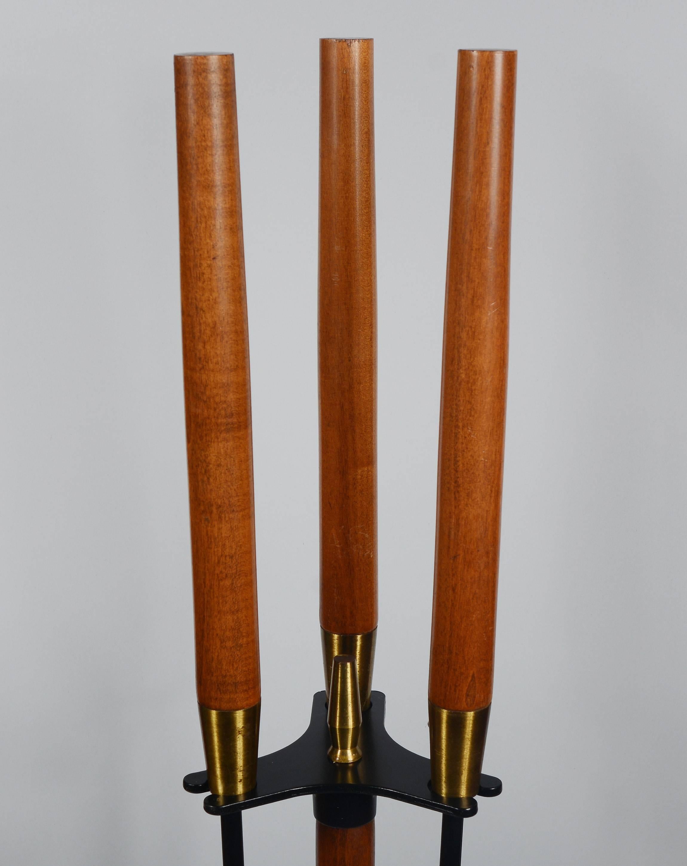Walnut handled three-piece fireplace tool set by Seymour Manufacturing. These have a brass detail on the handle and the top of the Stand. The set consist of a poker, shovel and broom. The iron has been given a new black lacquer finish. The walnut