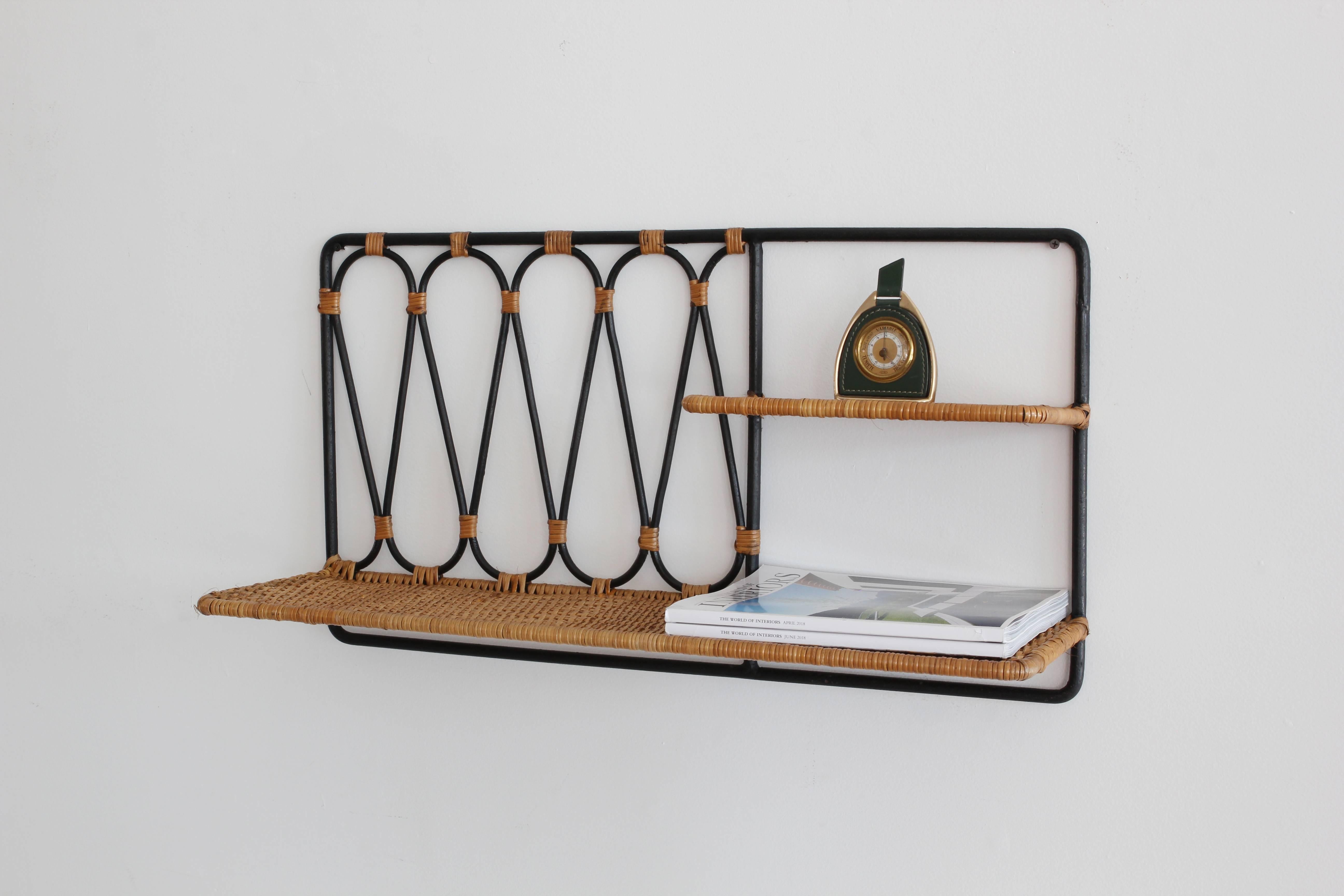 Exquisite French wall shelf with curved iron and wicker wrapped shelf and details.