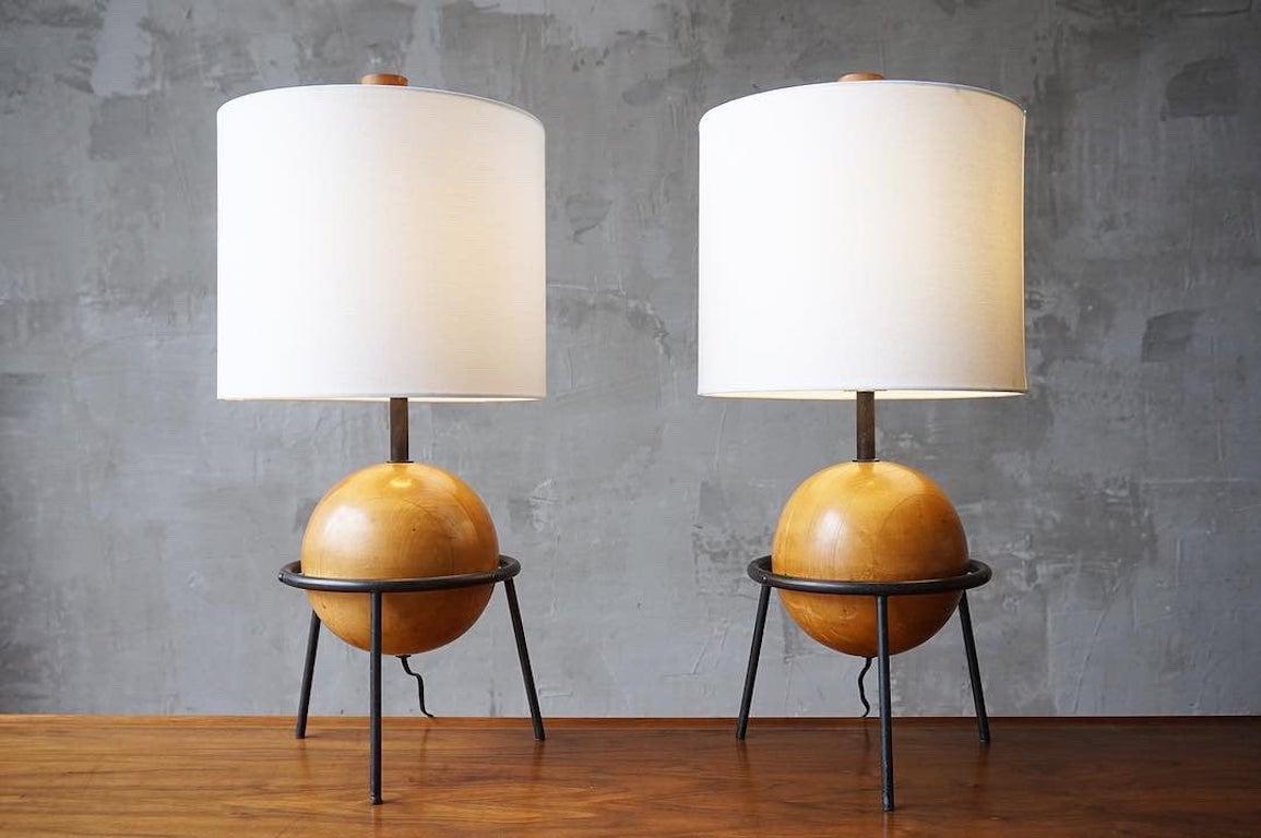 Beautifully crafted pair of California modernists table lamps in iron and wood, designed by Albert Blake, circa 1950s. 

Both in excellent original condition with a rich and warm patina. 

Harps and finials included, shades are not. 

Price is