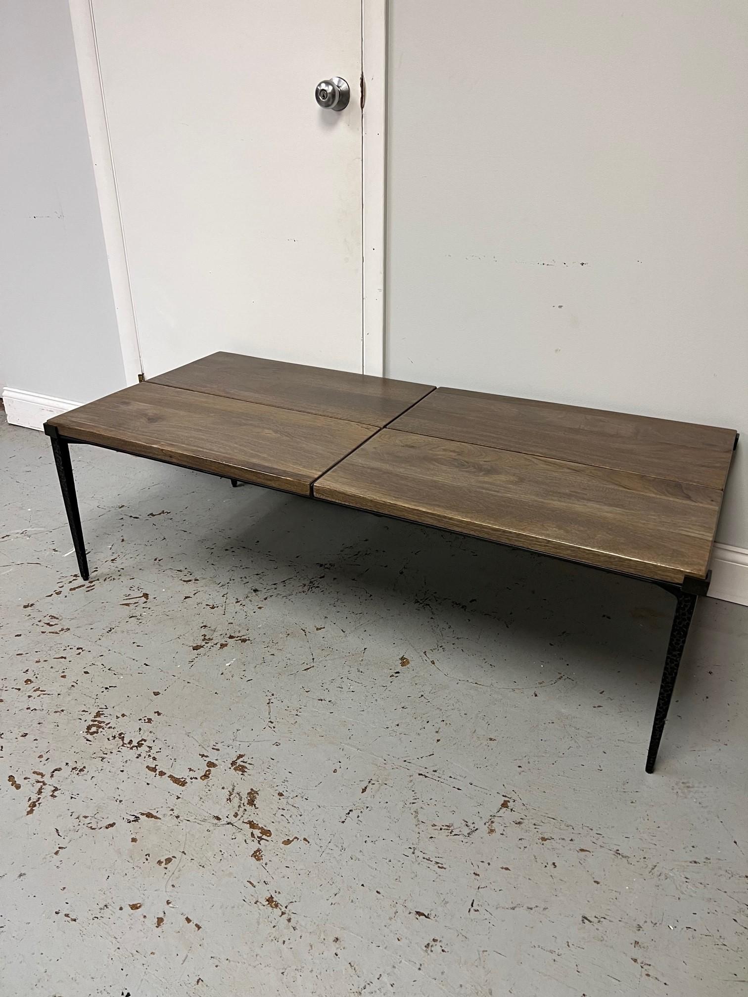 This is a great iron and wood coffee table imported from India. With its thin decorative iron legs and four hard wood panels it has a good look. The legs are thin but are very sturdy you can sit on this coffee table. It is a used piece and has some