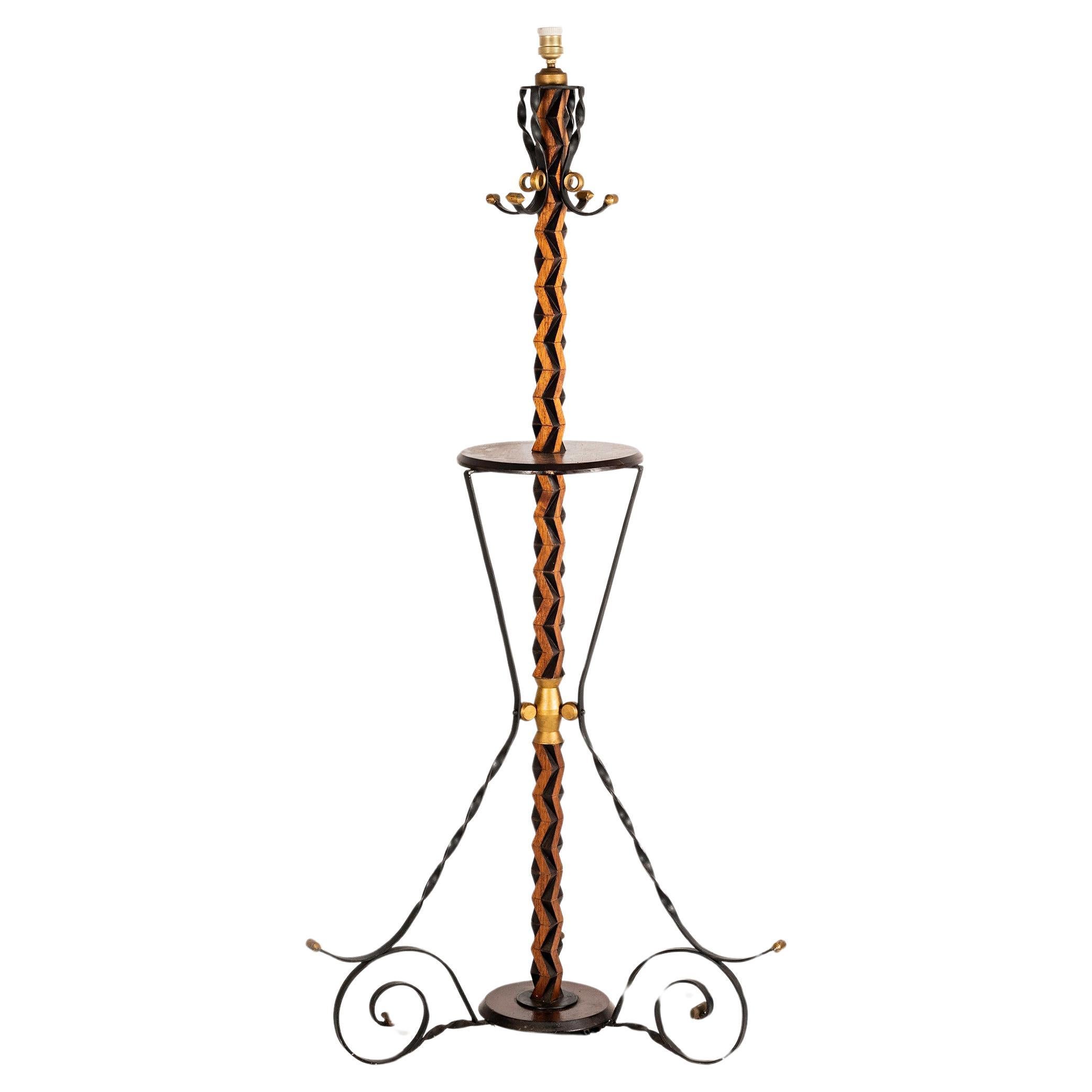 Iron and wood Mid-century french floor lamp in the style of Gilbert Poillerat