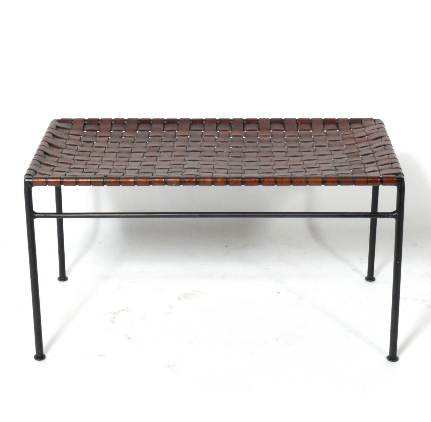 Iron and woven leather strap bench, in the manner of Lila Swift and Donald Monell, American, circa 1980s. Retains warm original patina.
