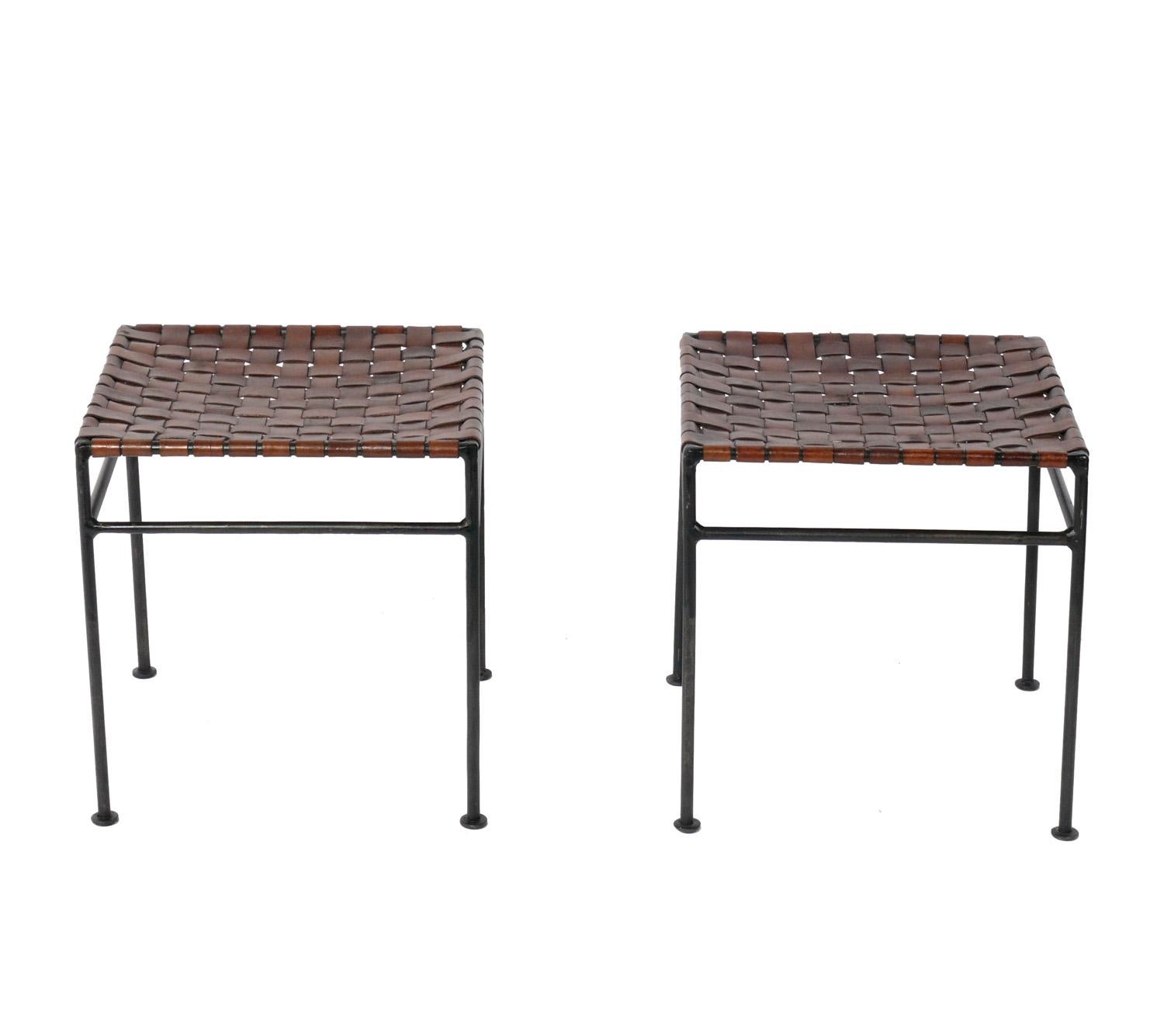 Iron and woven leather strap stools, in the manner of Lila Swift and Donald Monell, American, circa 1980s. They retain their warm original patina.