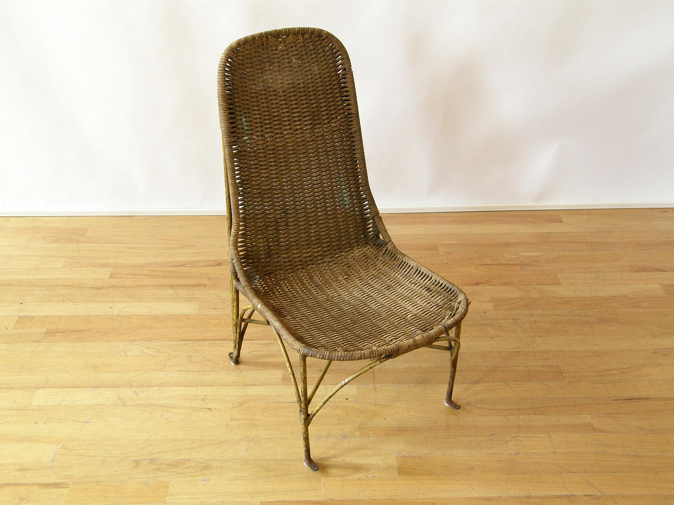 This pilot's or passenger's seat from a circa 1920s airplane is an excellent example of early 20th century industrial design. The frame is made from rod iron, and the seat and back are woven rush. The rear of the seat back has a cleverly integrated