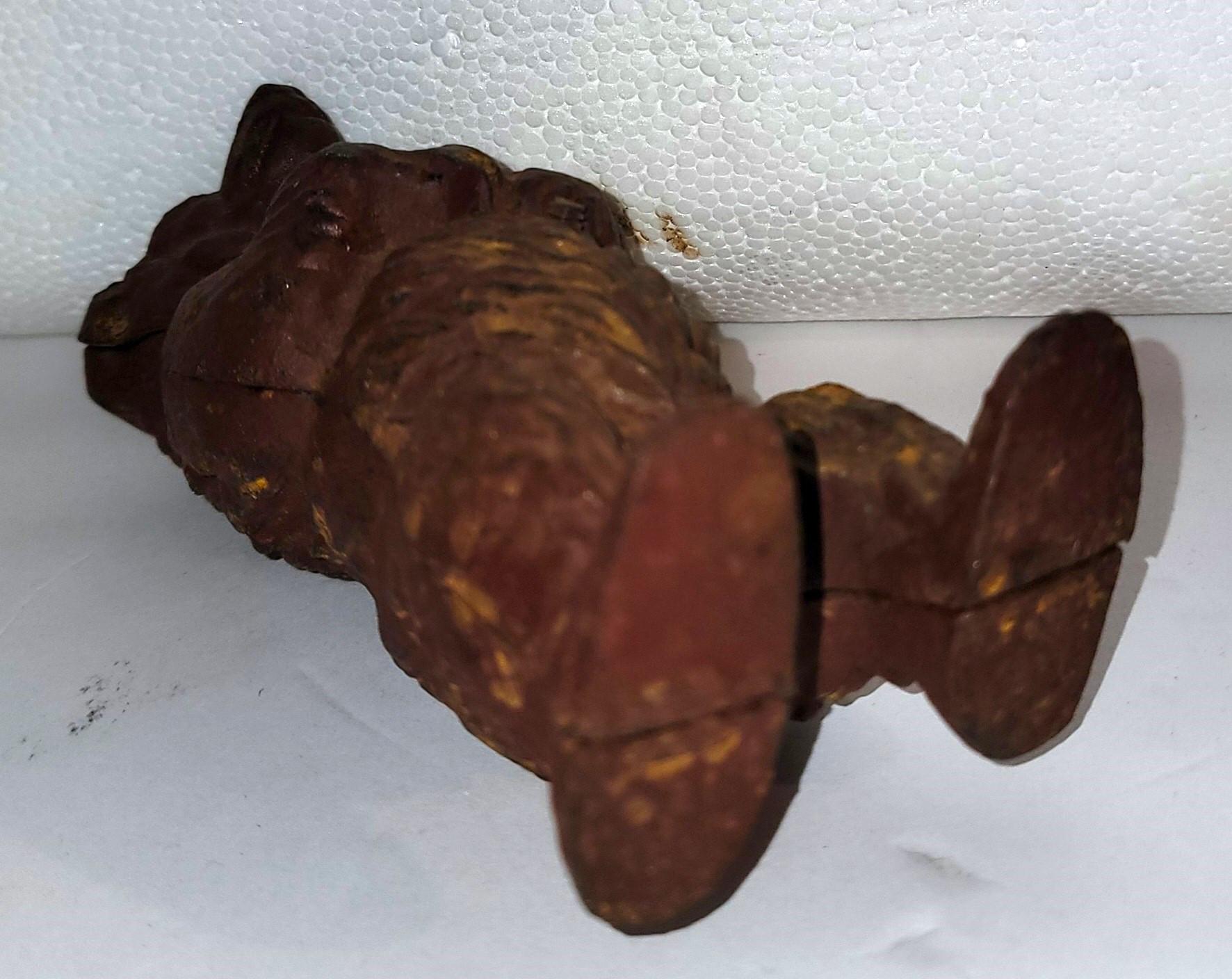 Early 20thc Painted iron Coin bank. Wonderful age and patina to the body. Old brown paint. Iron mold has wear to bod y from age and use.