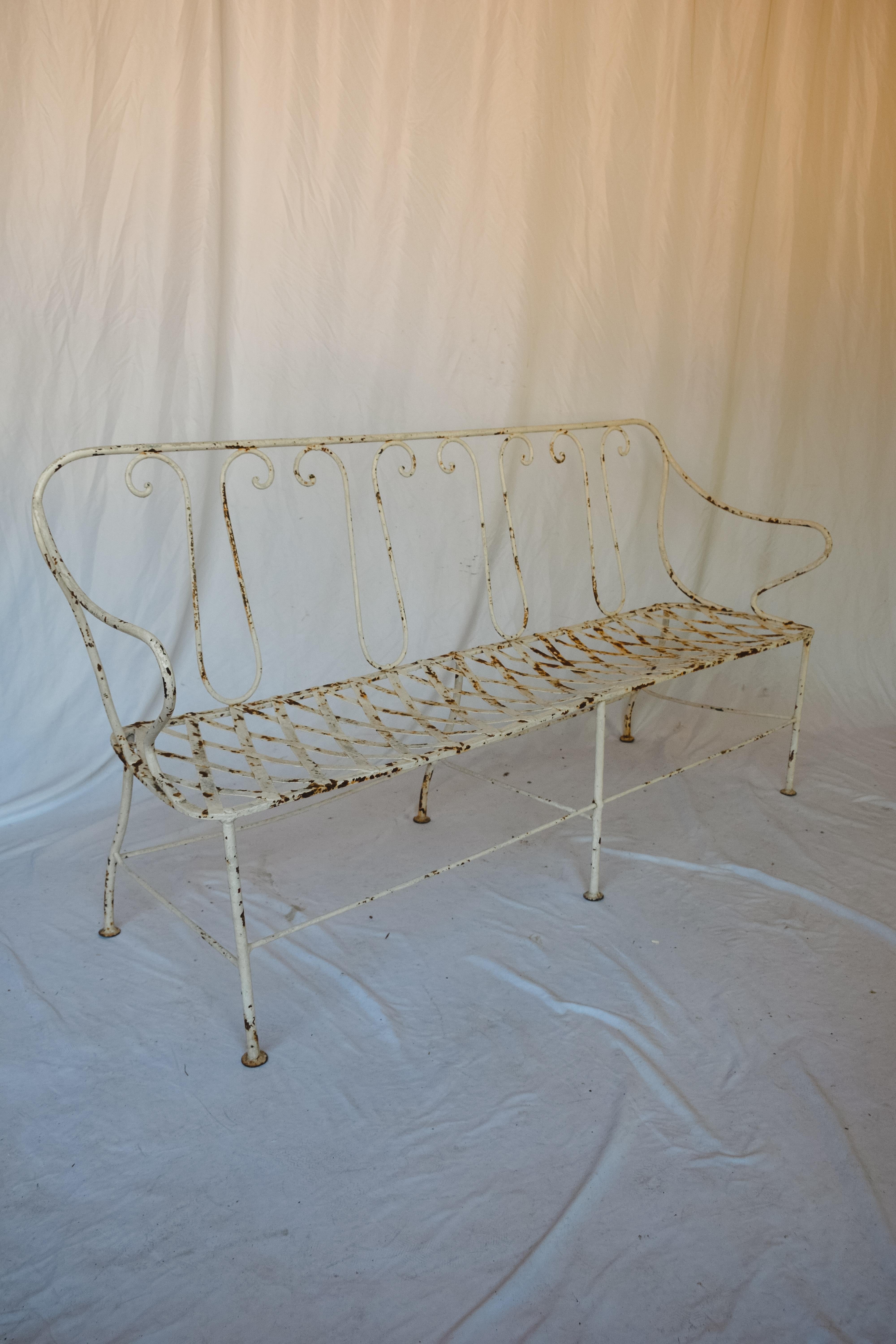 This French antique metal garden settee is from the Second French Empire , which was the 18-year Imperial Bonapartist regime of Napoleon III from 14 January 1852 to 27 October 1870. The arms are referred to as 