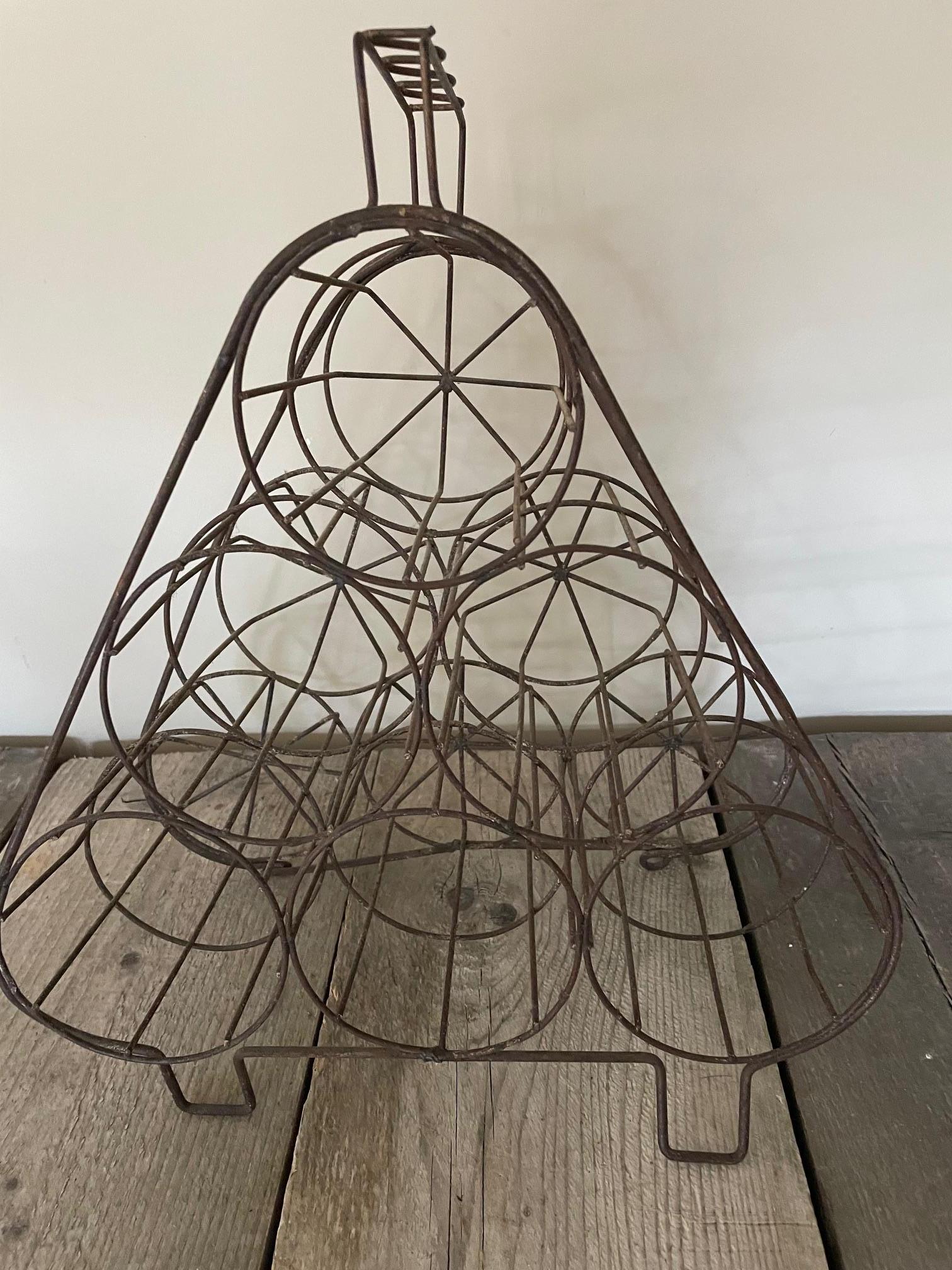 This bottle holder is made of finely worked iron and can be placed on a bar or in your kitchen. The original patina is attractive.
It holds six bottles.