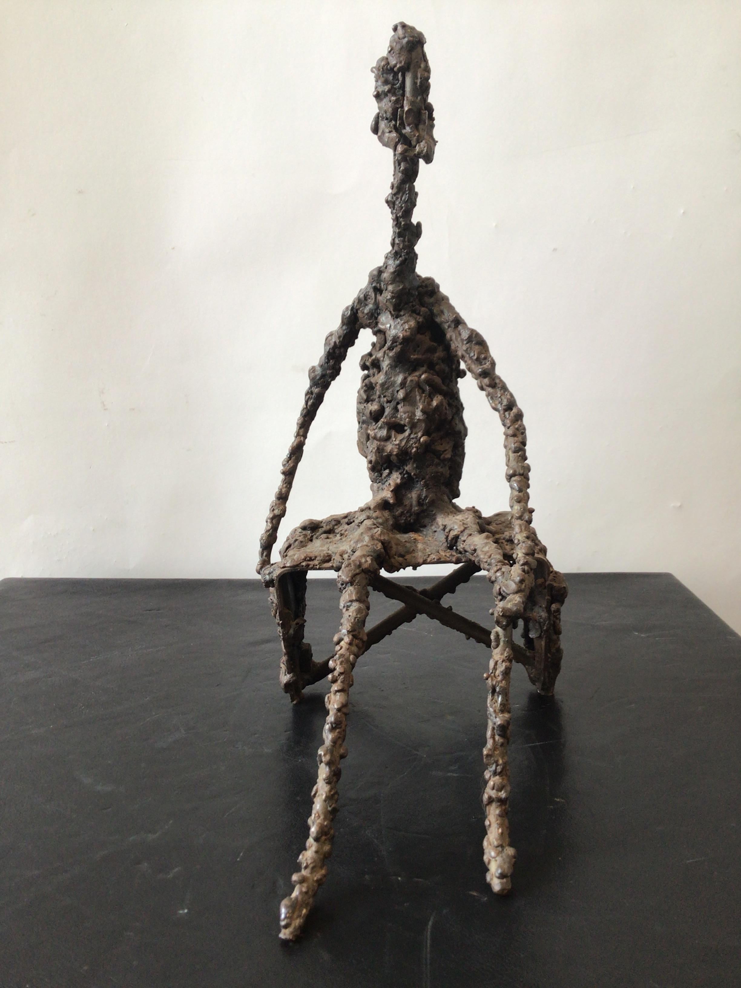 1970s Brutalist iron sculpture of a seated man. Unsigned.