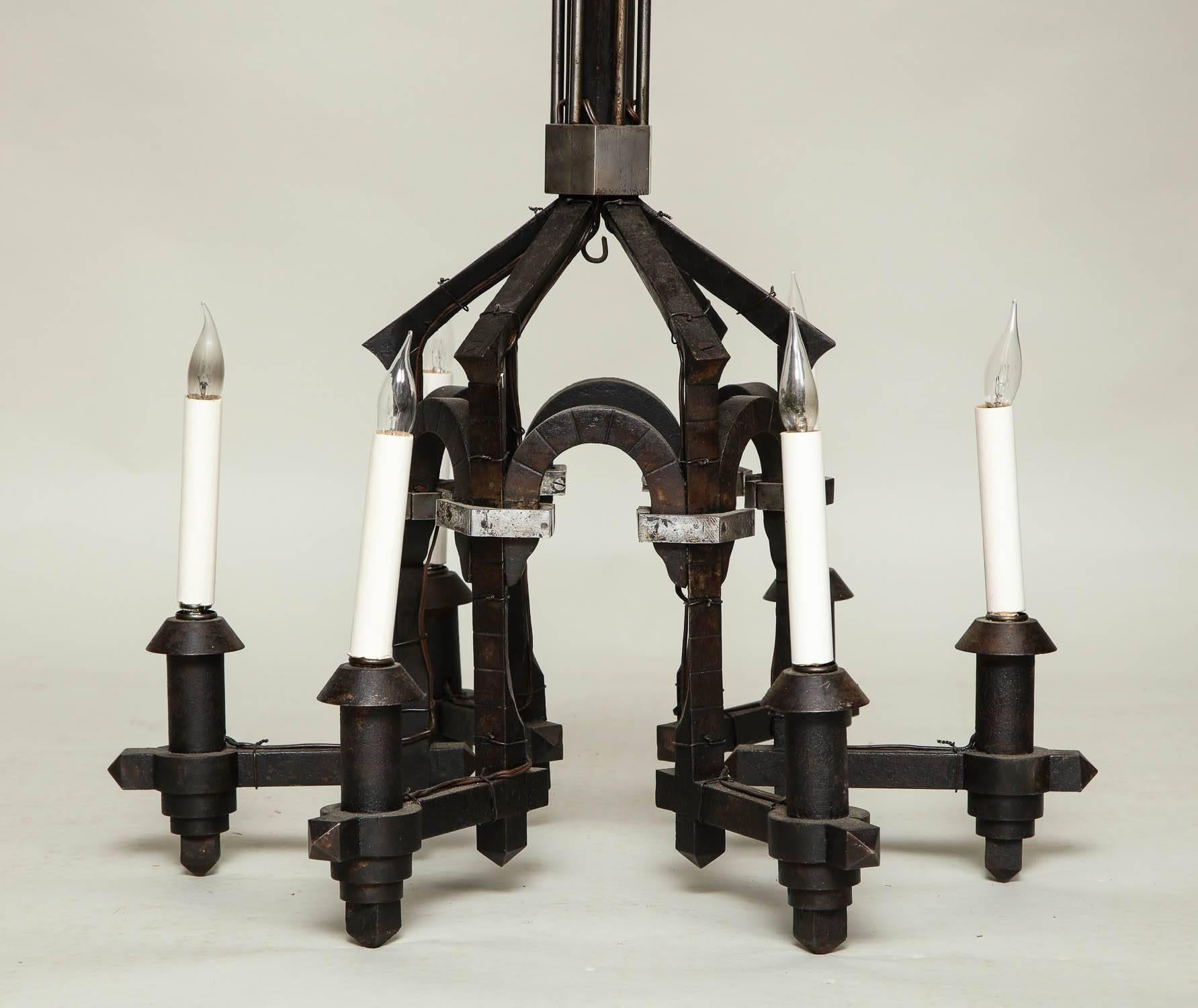 Forged architectural iron six-light chandelier in blackened wrought iron with bright polished details, beautifully crafted from mortised and peened iron with a slightly Neo-Gothic style.