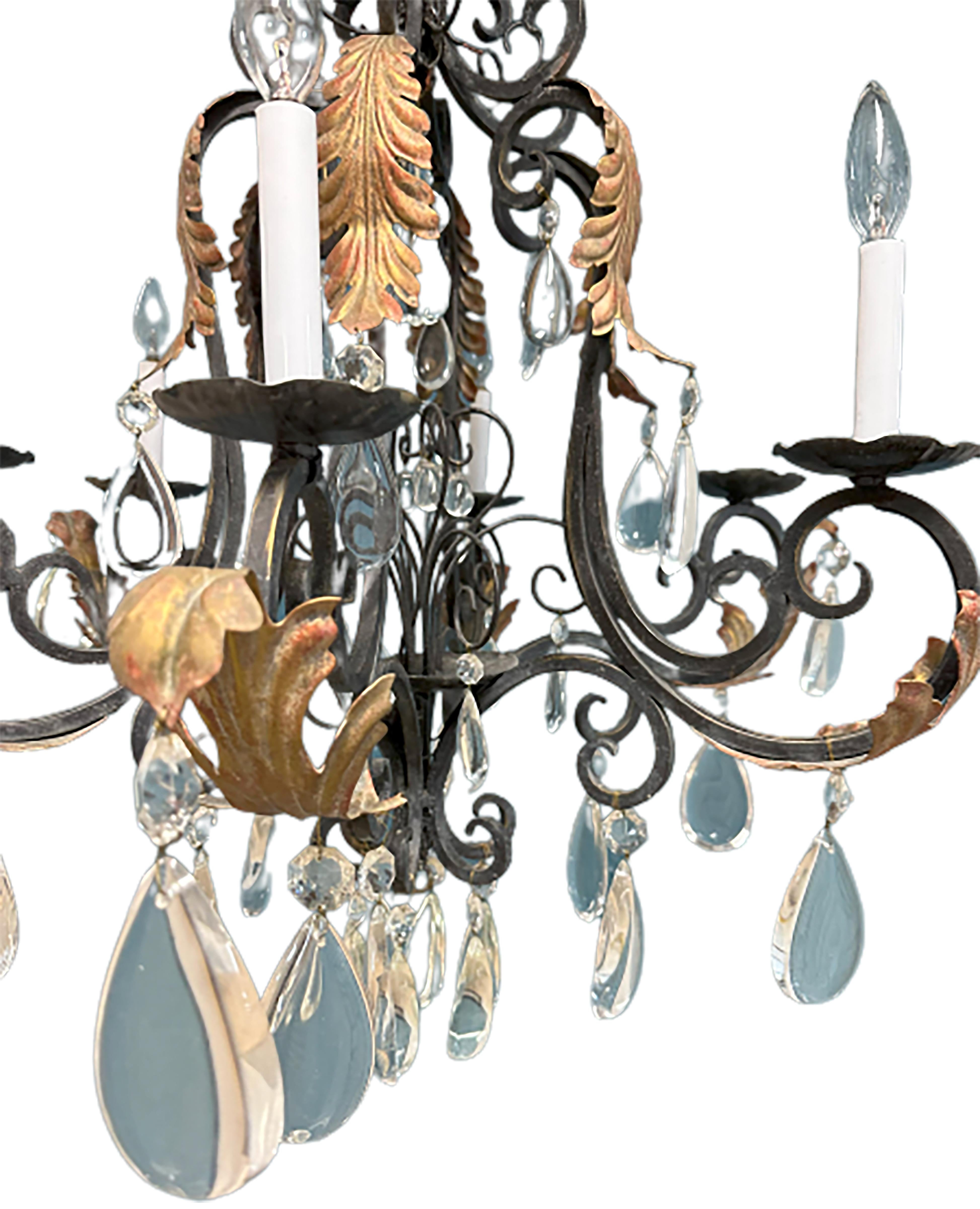 A handsome handmade iron chandelier. 21st century made. Gilt acanthus leaves with glass cut droplets ornament the elegant french curves. 

In very good condition.

No obvious markings on the piece. 

This piece has an elegant flow to its shape and