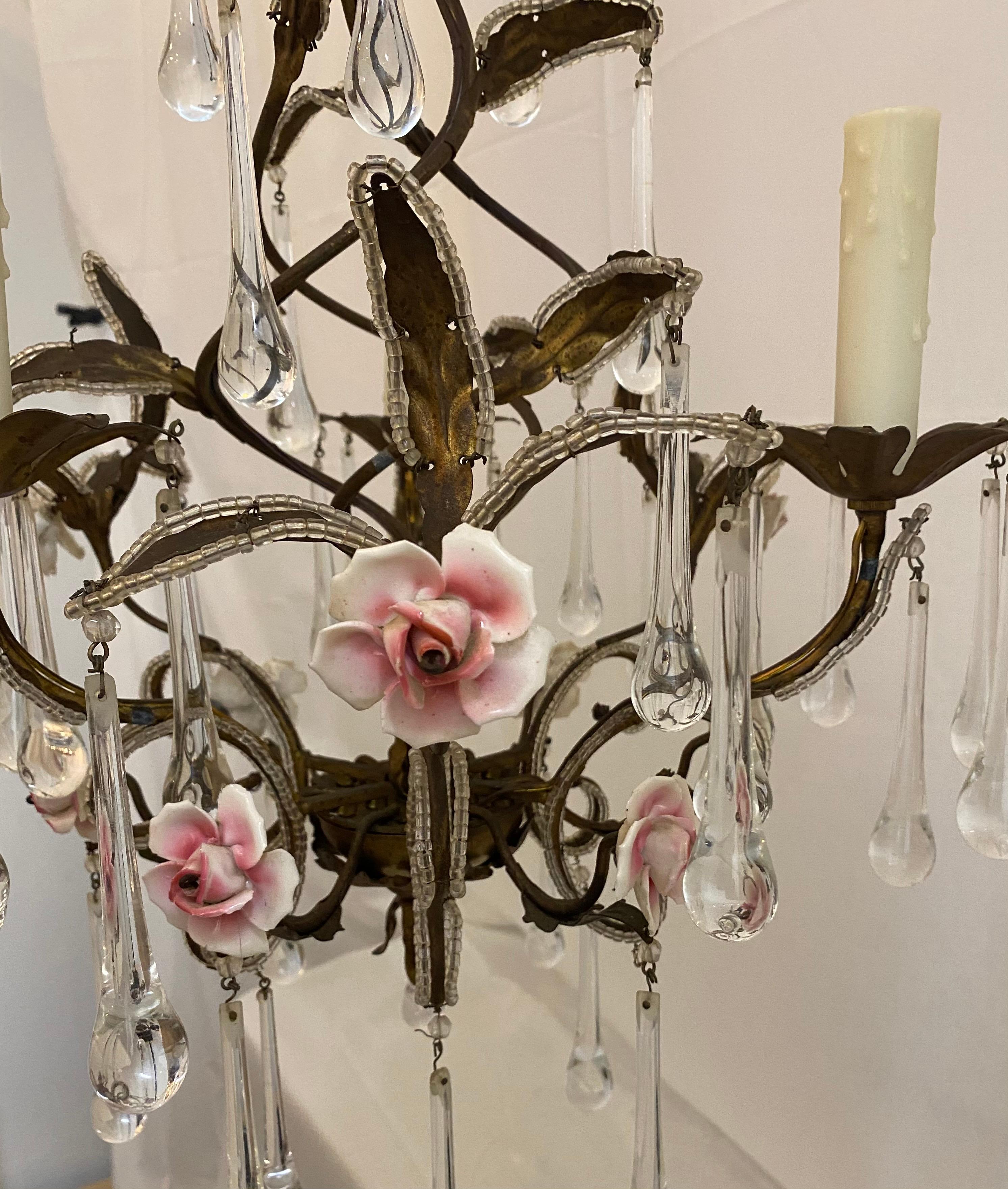 Small iron chandelier with beaded crystals, and small opaline pink and white roses. It has 3-light, and 3 - 4