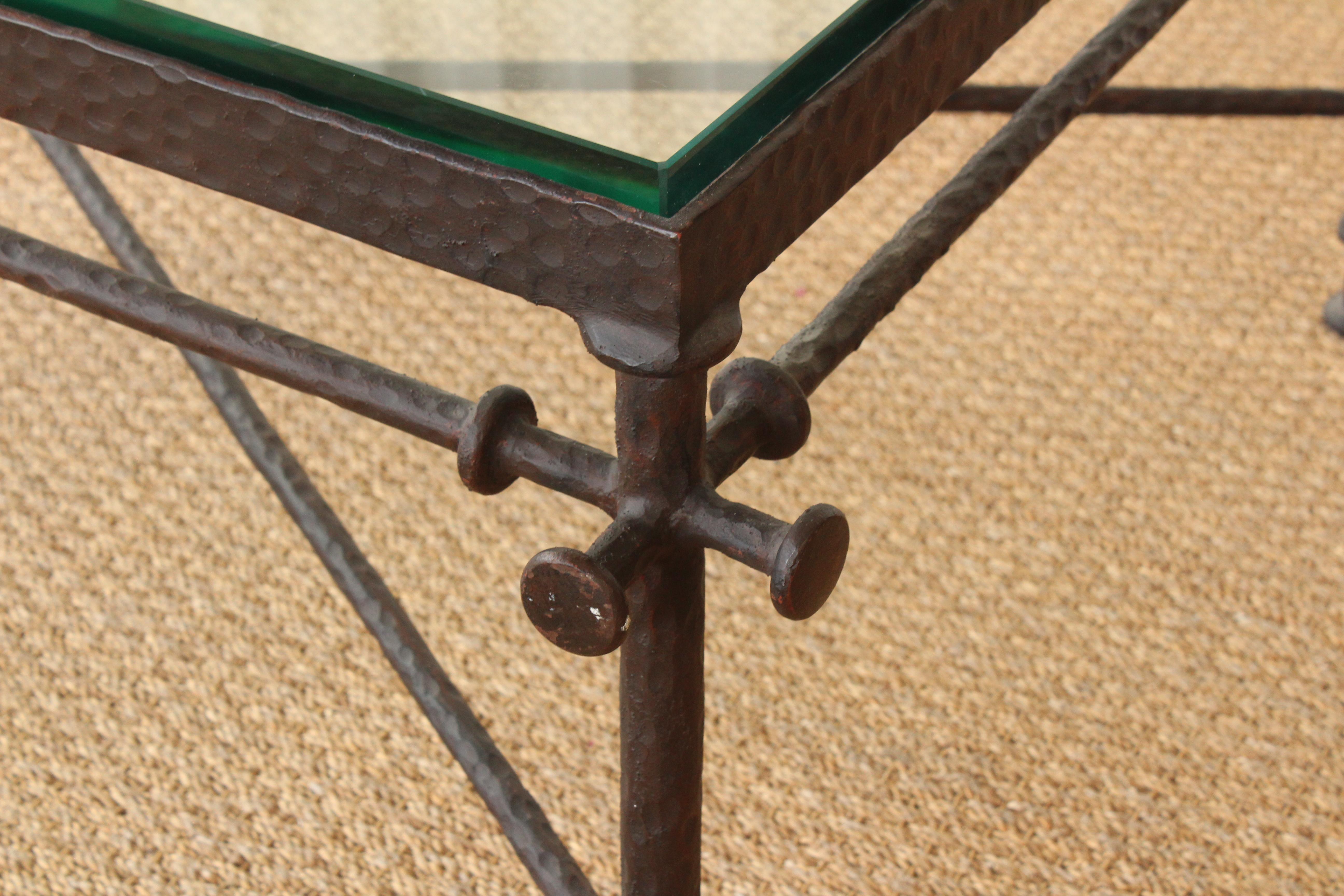 Solid hammered iron coffee table in the manner of Diego Giacometti. New glass top.