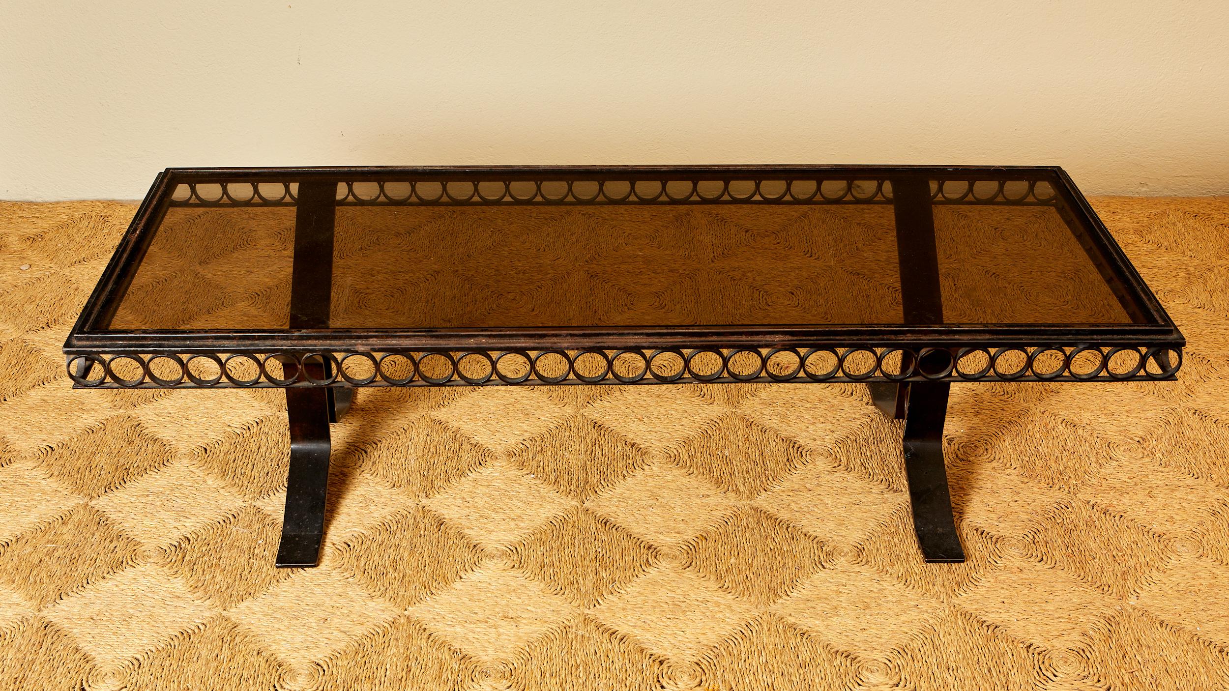 French Iron coffee table, smoked glass, circa 1940, France. For Sale