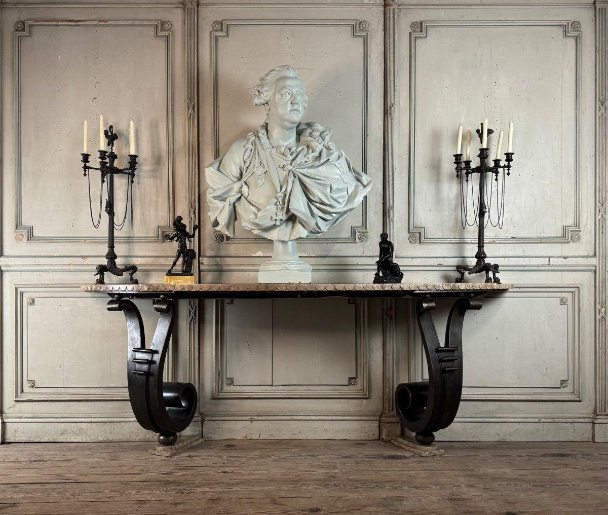 Monumental wrought iron console with double scrolling leg, top and bases in beige marble carved in a belt and on two levels. in the spirit of Raymond Subes