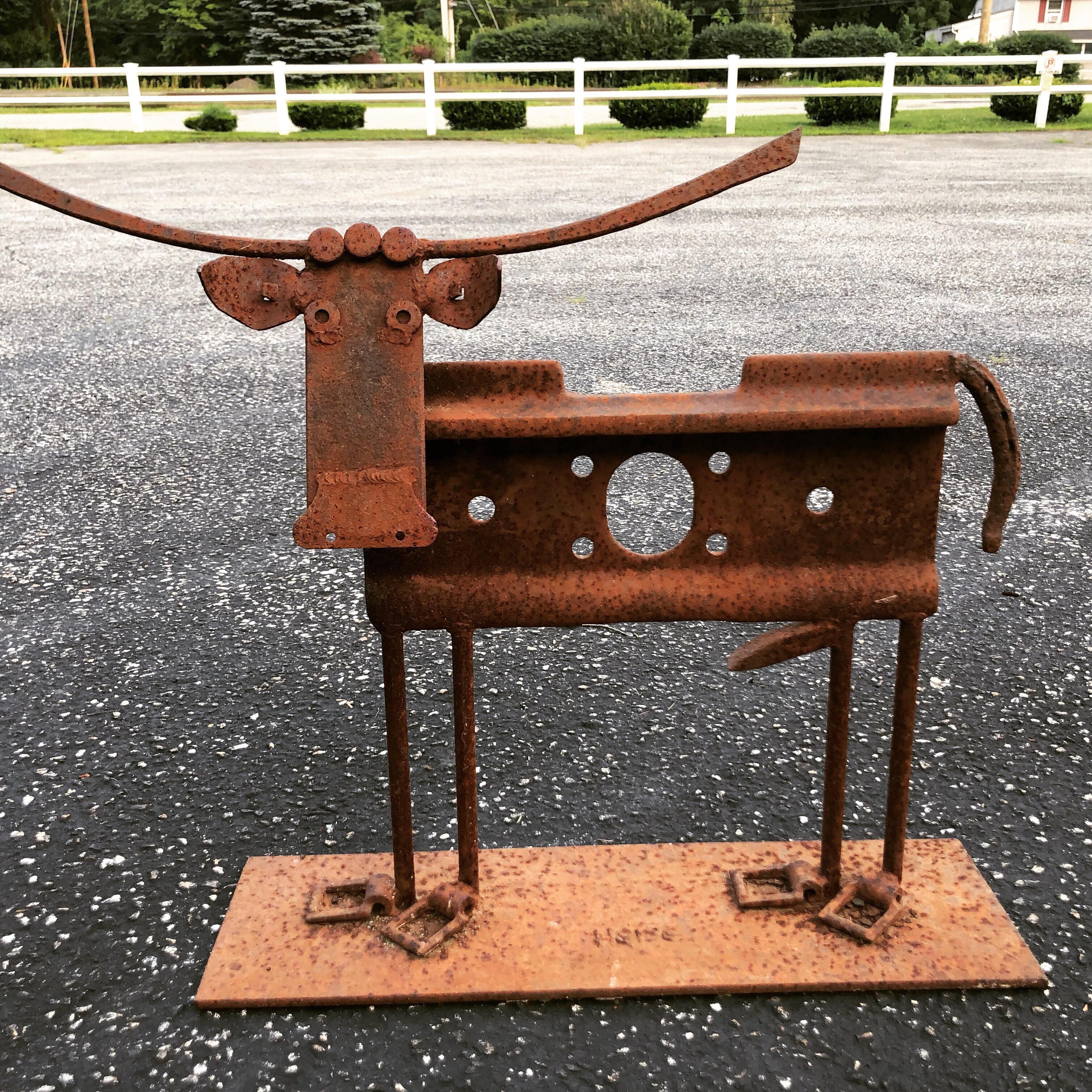 Signed Heiss iron cow sculpture. Junkyard style art by famous artist Heiss. Used pieces of scrap metal designed to form a sculpture. Great as a doorstop.