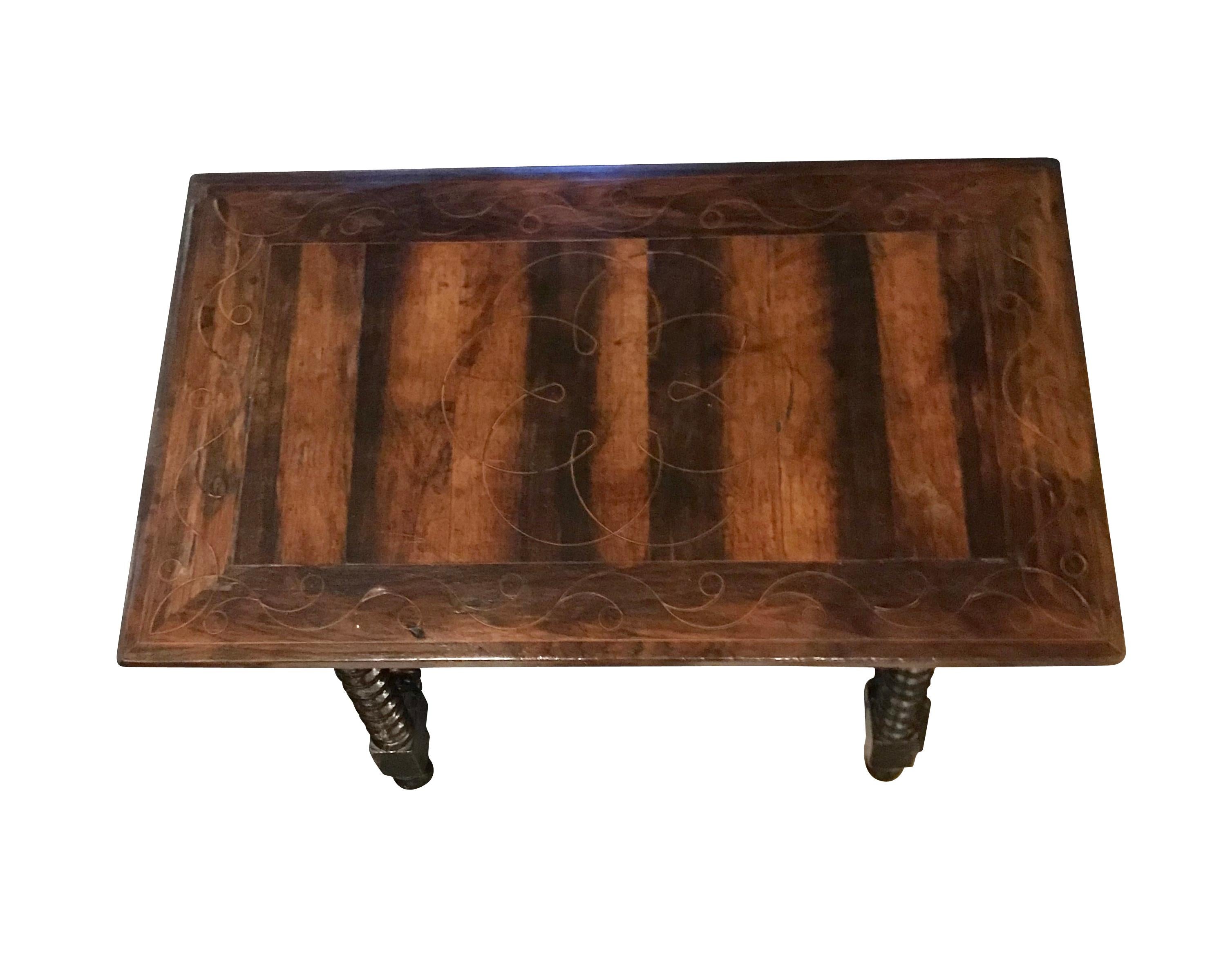 19th century traditional Spanish iron cross bar base rectangular wooden side table.
Decorative striped effect wood top.
Newly refinished.
 