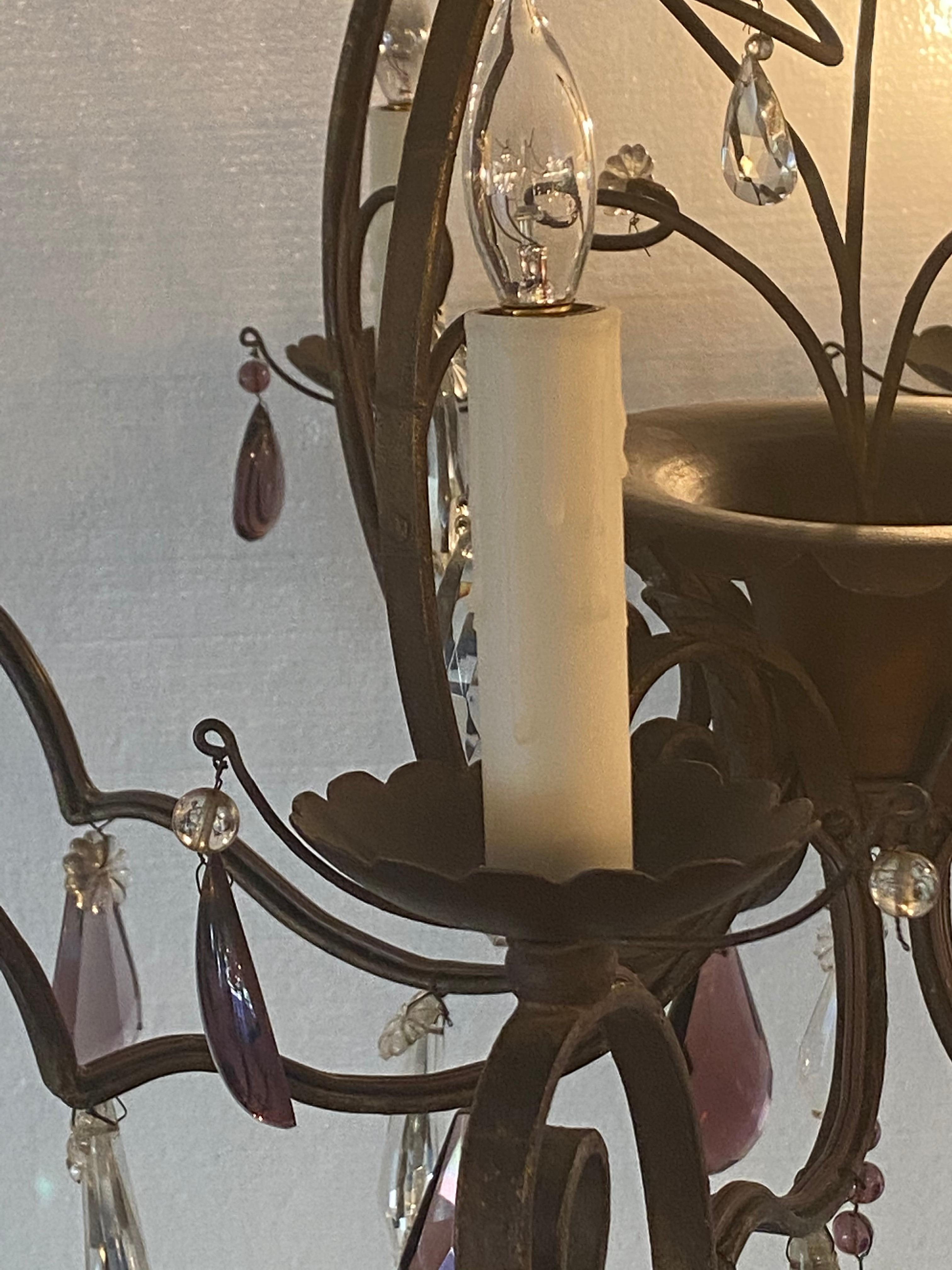Iron chandelier with plum and clear crystal. With eight lights, and eight 4