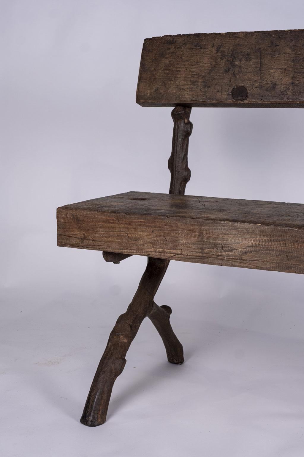 Belgian iron faux bois bench cast circa 1900-1920. Large thick plank back and seat supported by cast iron 