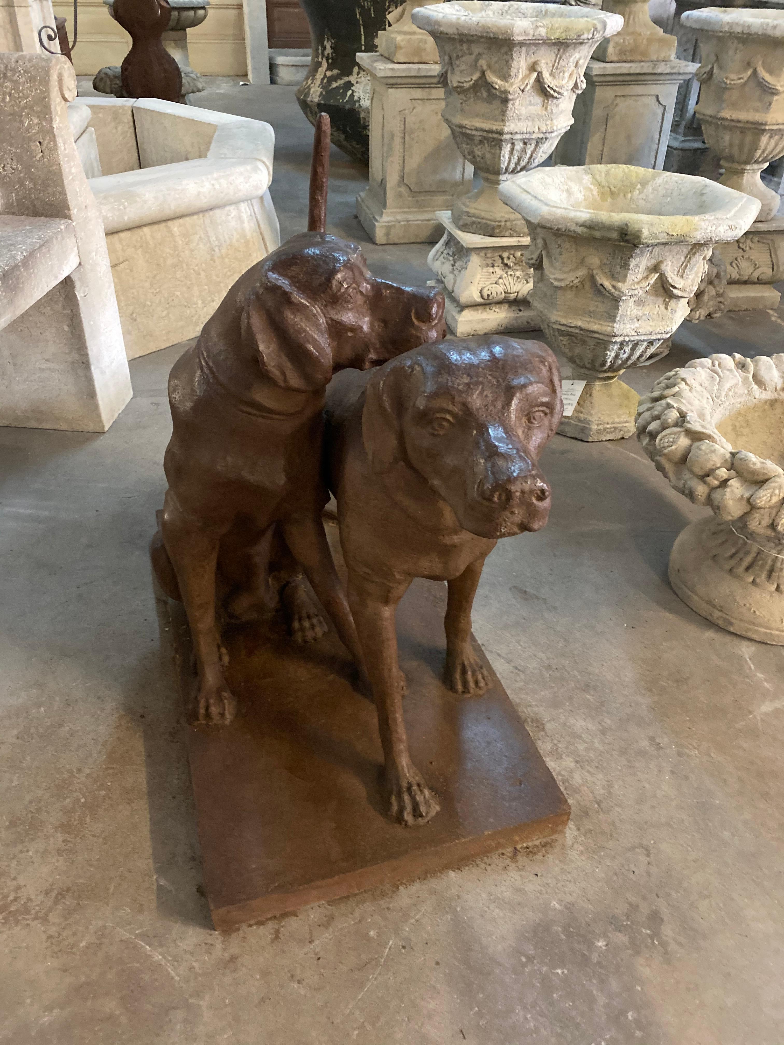 This iron statue depicts a pair of Labrador retriever dogs side by side. Buffed iron wax finish. 

Measurements: 31
