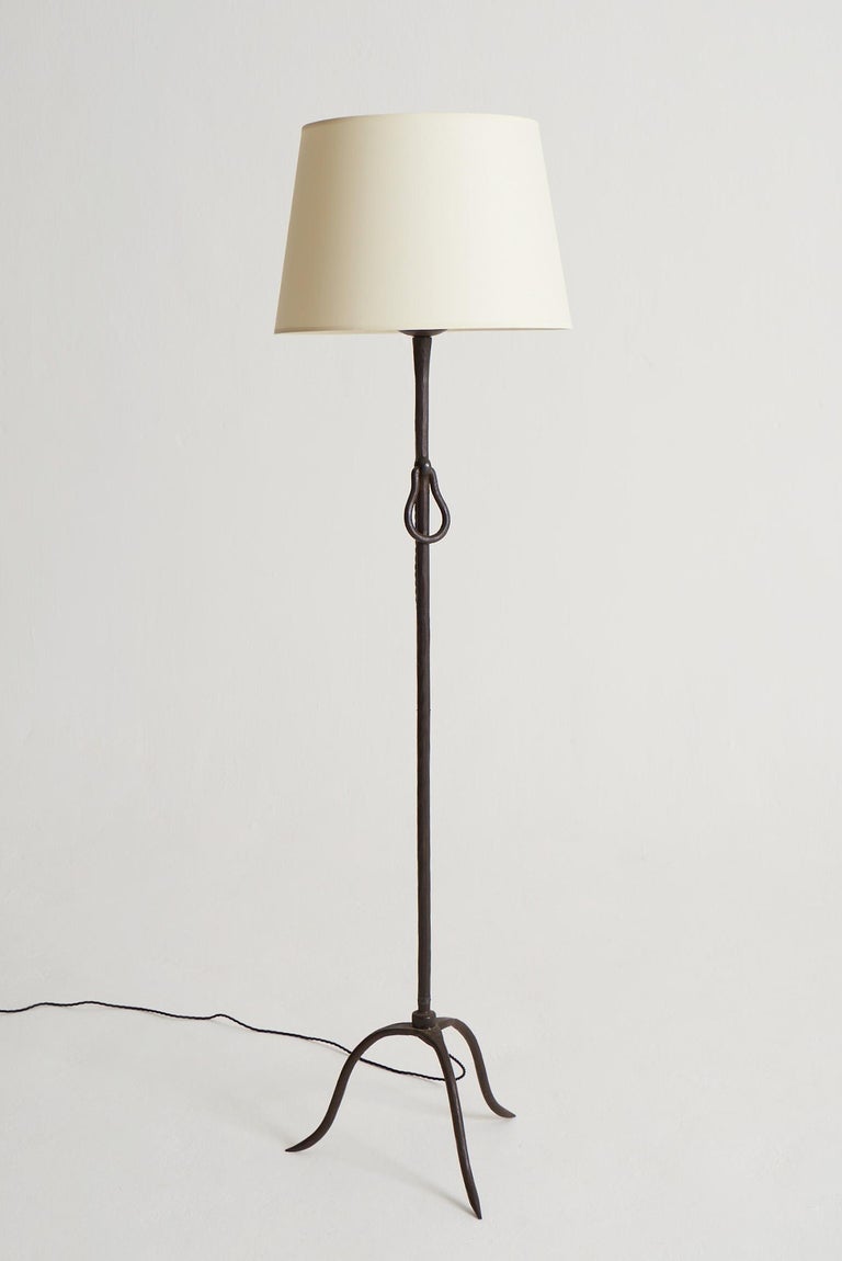 A wrought iron floor lamp, attributed to Jean Touret for Atelier Marolles.
France, Circa 1960.
Measures: With the shade: 165 cm high by 46 cm diameter.
Lamp base only: 140 cm high by 42 cm wide. 
--- 

Jean Touret moved to Pezay, a rural area