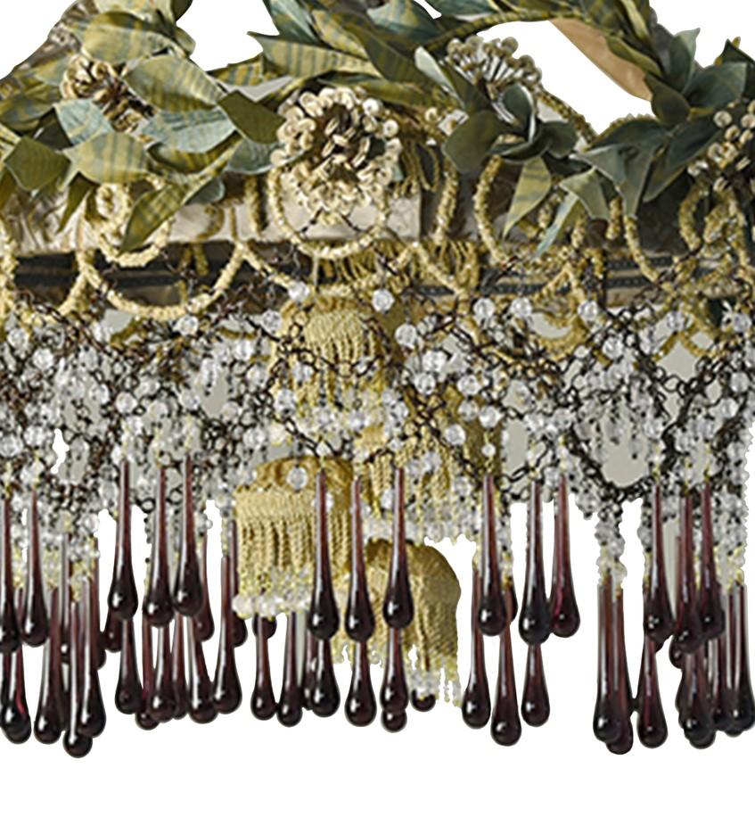 A striking balance of bold and ethereal, this exquisite chandelier will infuse any decor with timeless elegance. Reminiscent of a flower bush in a French garden, the sturdy frame is marked by a delicate two-toned, green and orange fabric covering