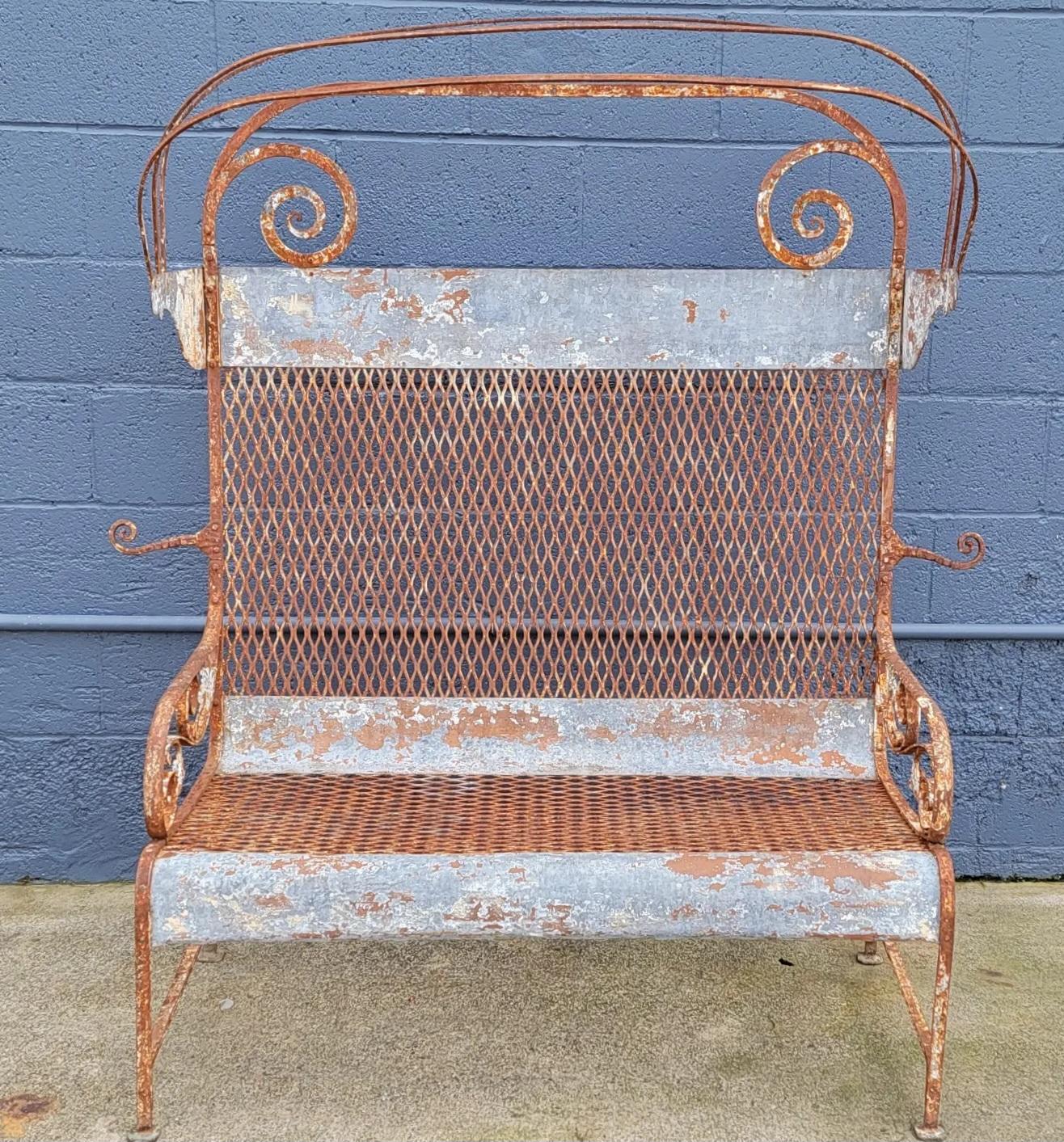 Unusual iron patio bench with retracting canopy. Hand made of mixed metals, cast and wrought iron, steel and galvanized steel. Beautiful patina from outdoor use. Structurally very solid. Retracting canopy utilizes 3 folding iron bars, fabric absent.