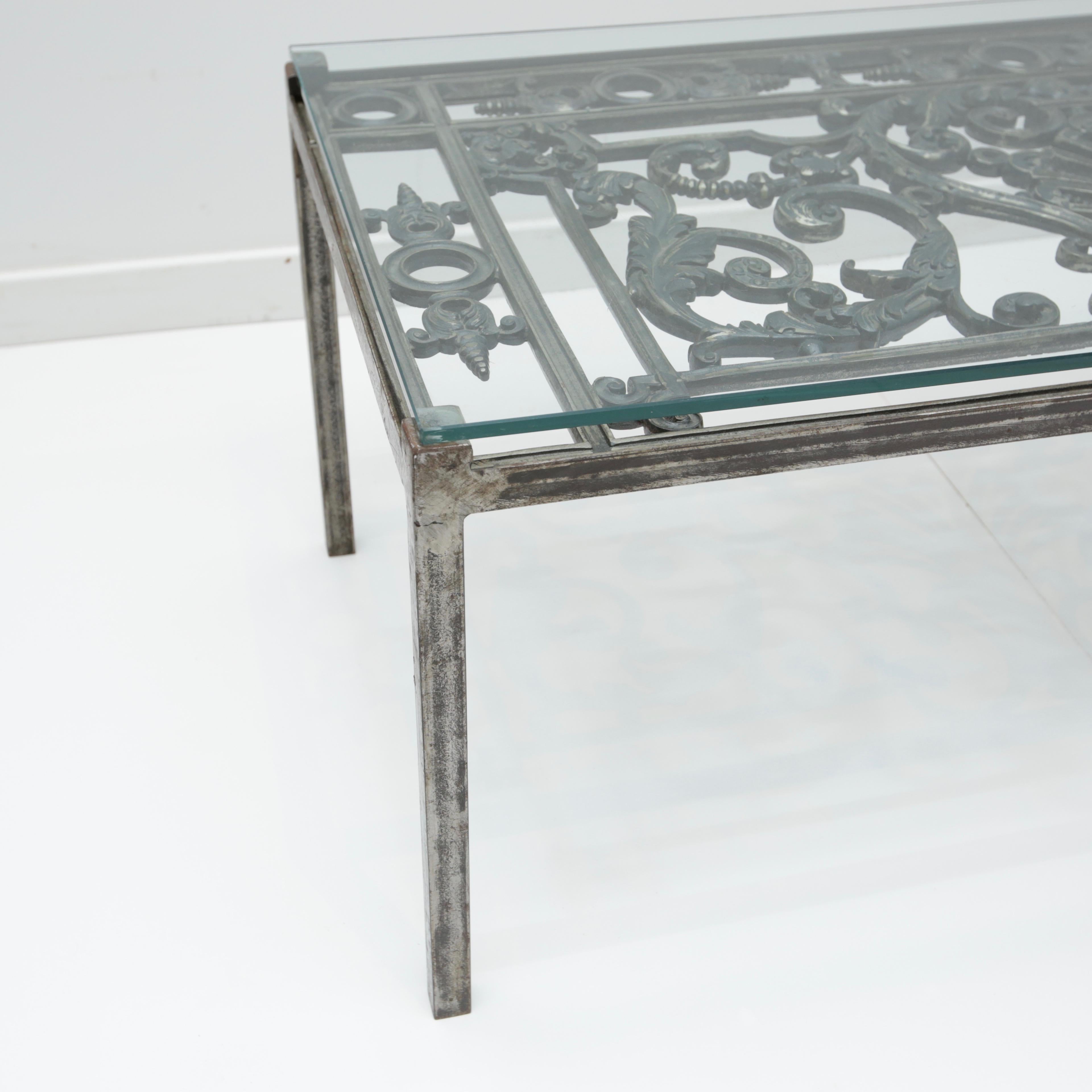 Iron gate style coffee table with 3/8th thick glass top.