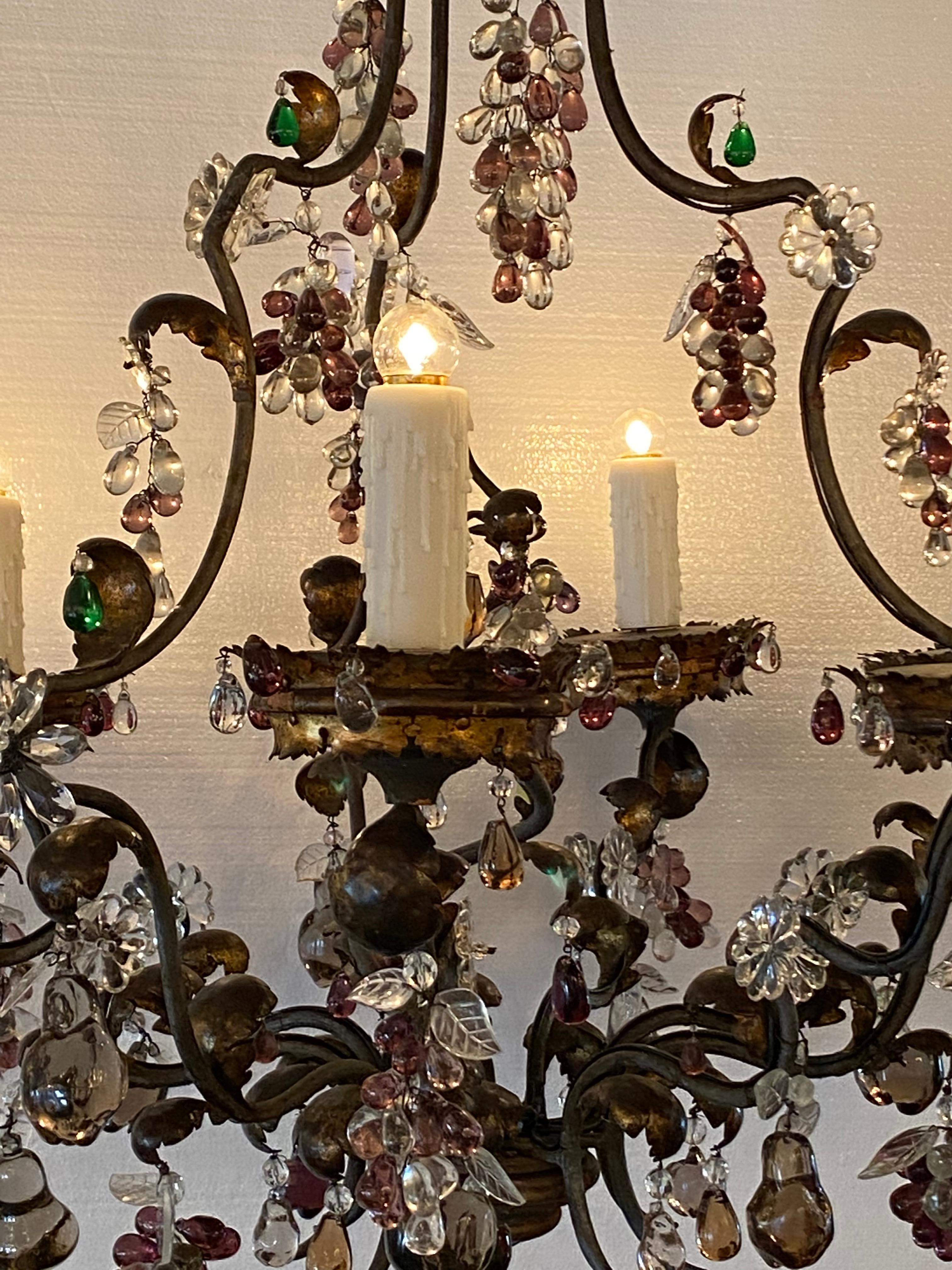 Iron and gilt tole with six lights; having grape, apple, and drops. Main colors are purple and clear, chandelier comes with 6 - 6