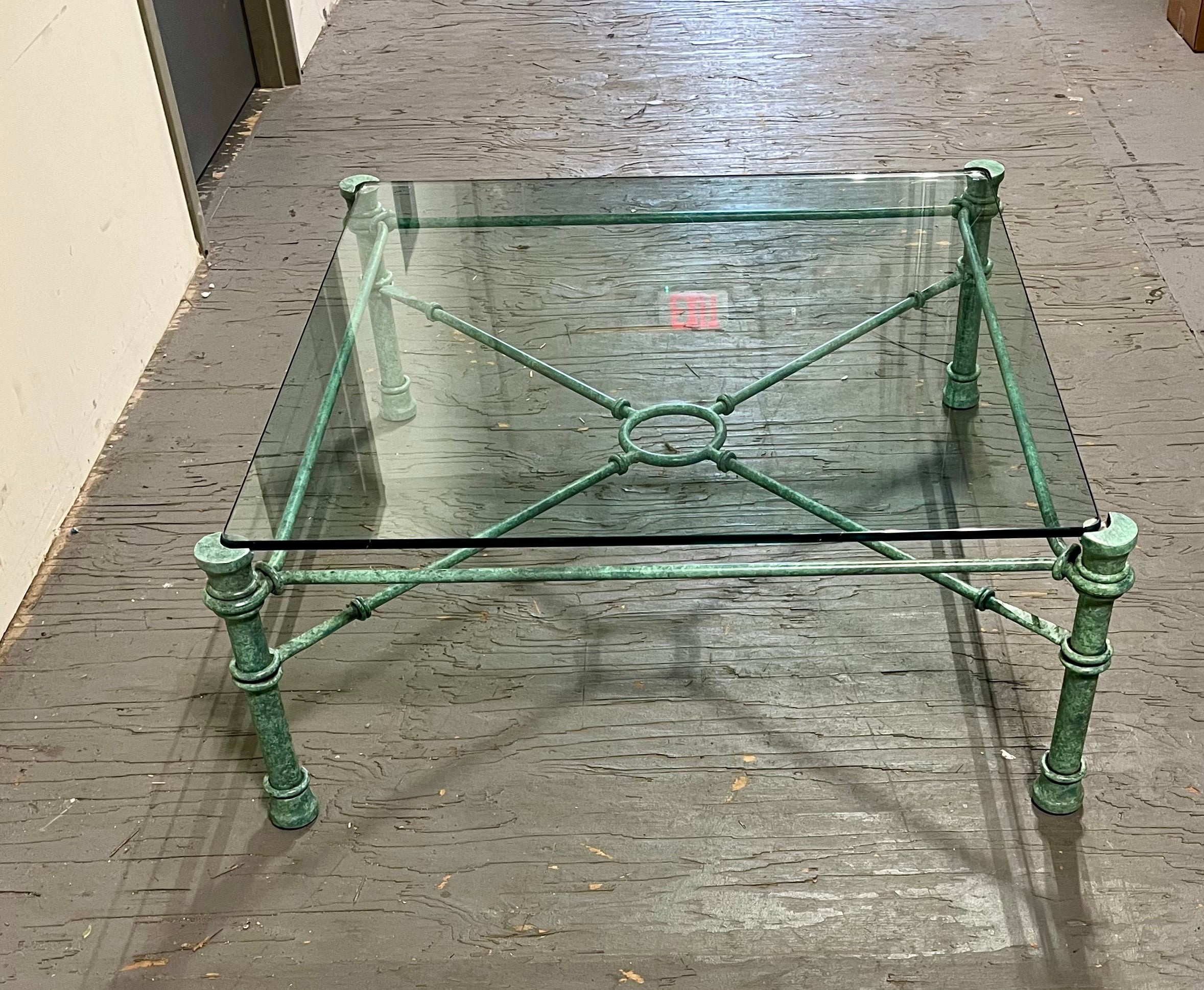 Classic Giacometti style large patinated bronze verdigris wrought-iron welded steel base. Water rounded edge glass inset top. Wonderful depth in detailing. 
Curbside to NYC/Philly $350