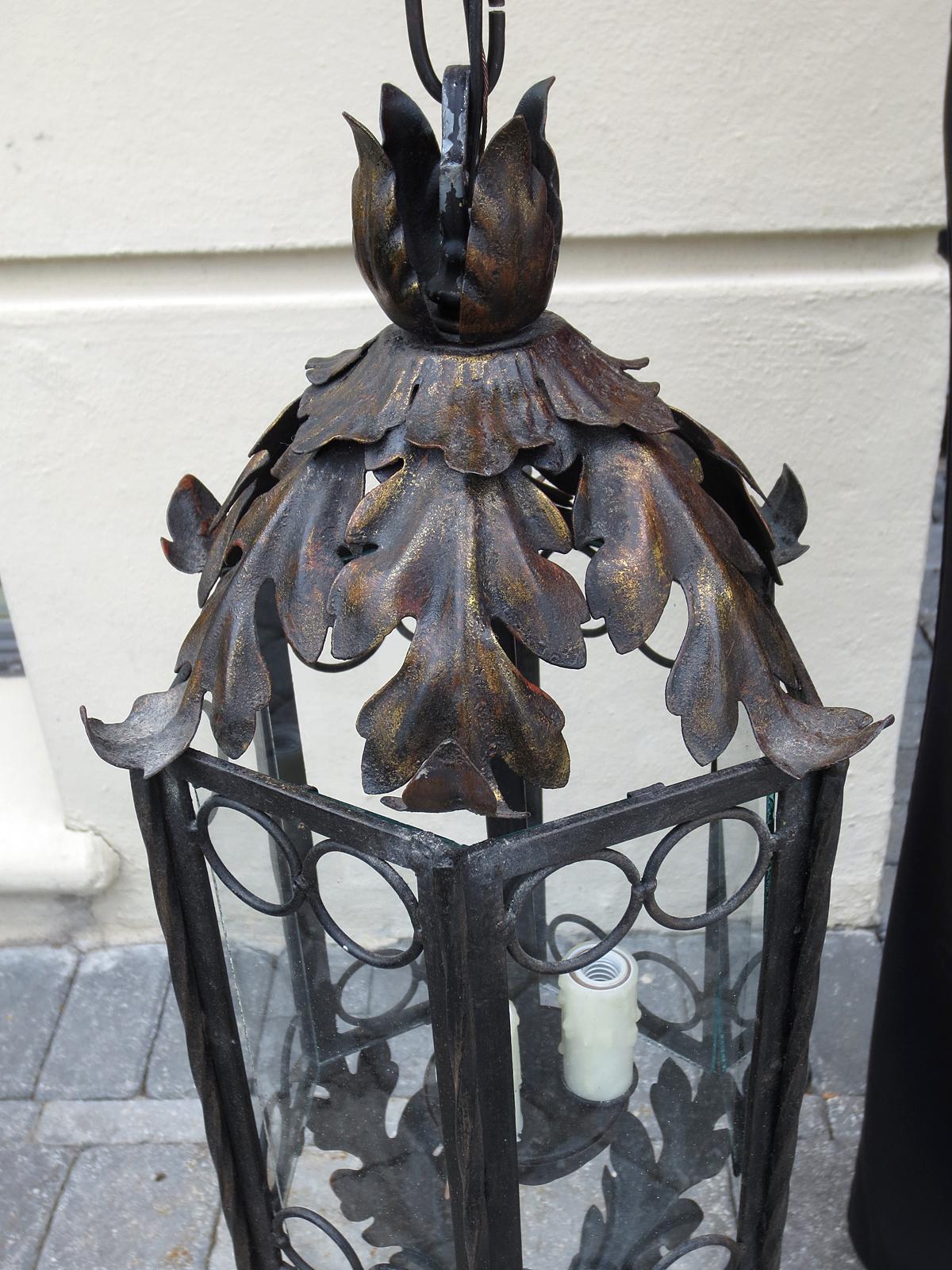 Iron and glass three-light lantern with circle and acanthus leaf motif, circa 1900
New wiring.