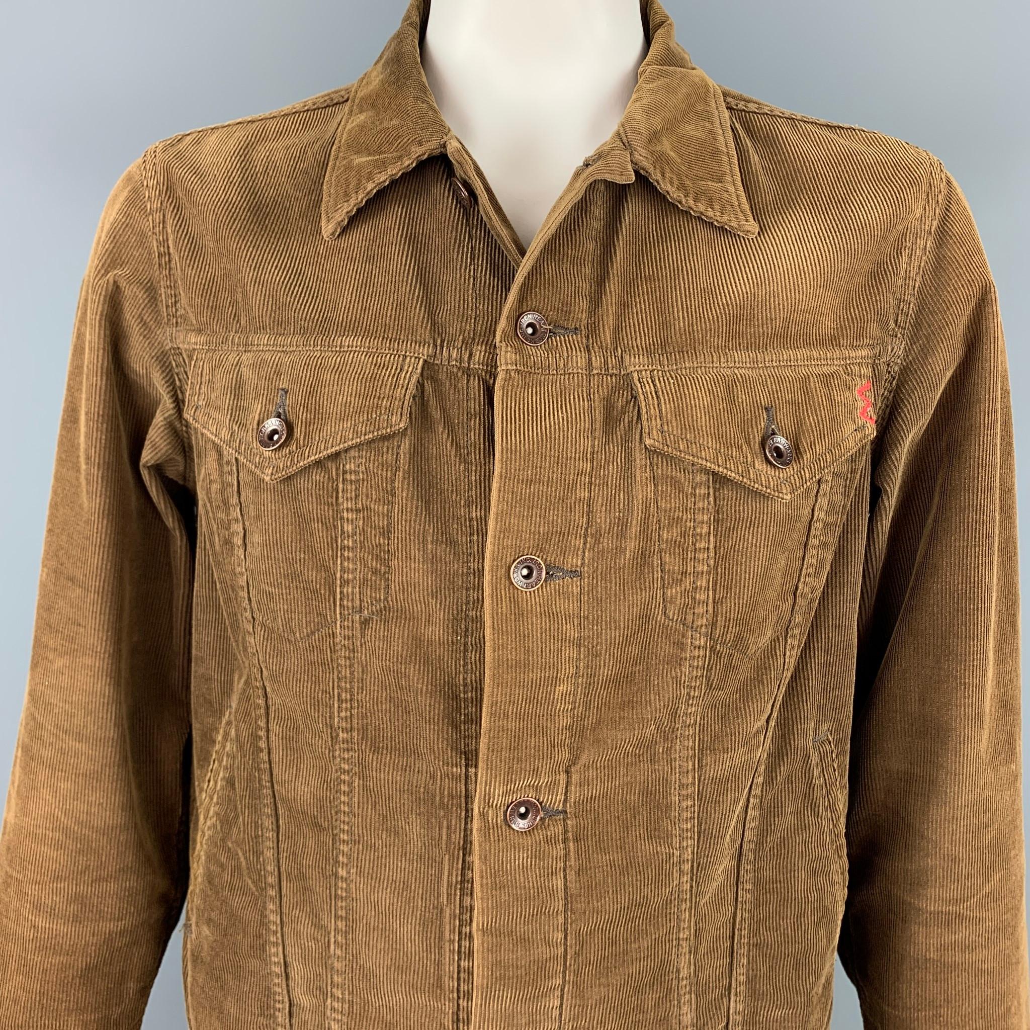 IRON HEART jacket comes in a brown cotton corduroy featuring a trucker style, front pockets, spread collar, an a tack button closure. Made in Japan.

Very Good Pre-Owned Condition.
Marked: 44

Measurements:

Shoulder: 19 in.
Chest: 44 in.
Sleeve: 27