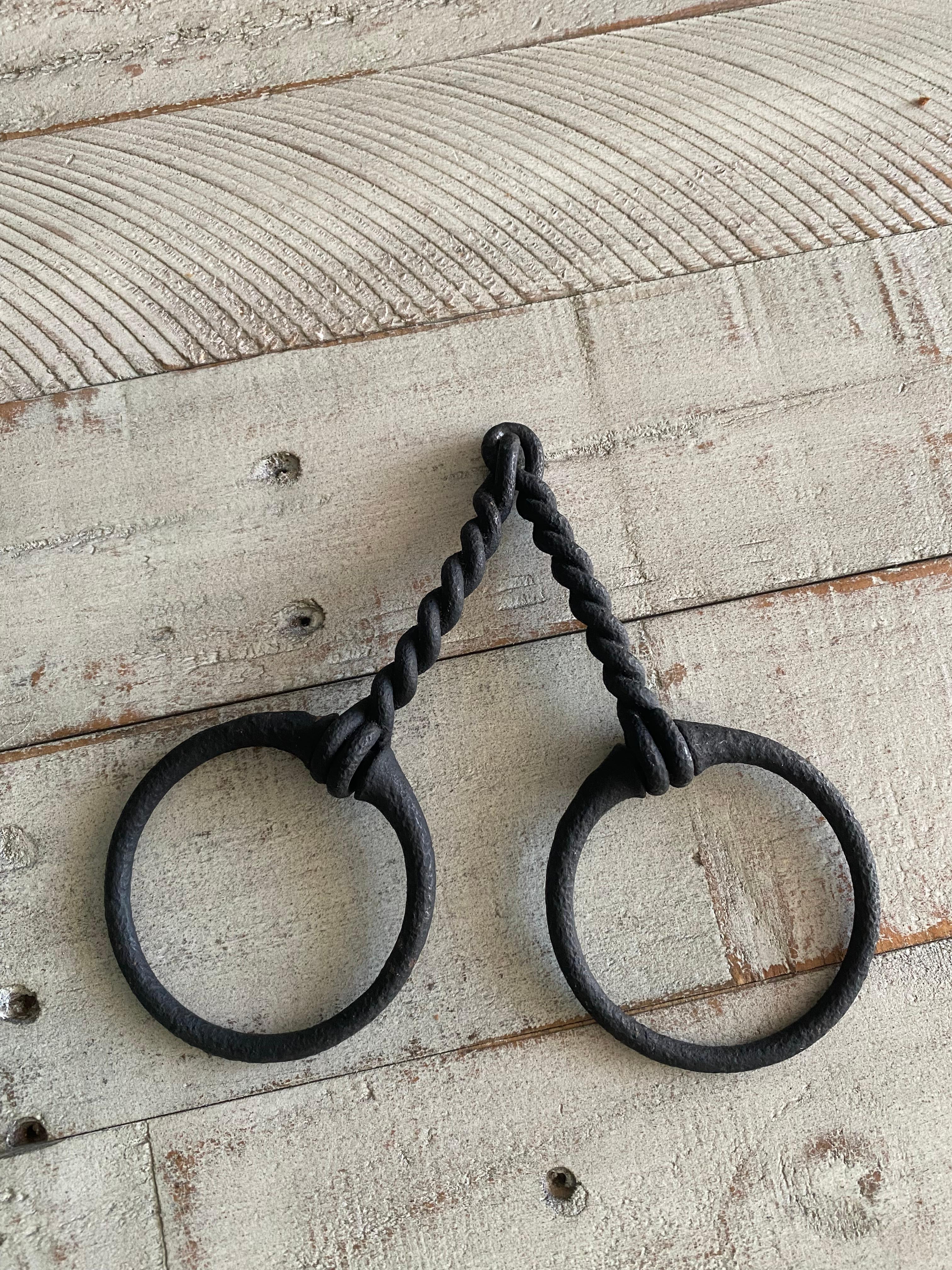 Unique handmade twisted iron Gucci-style horse bit paperweight or sculpture. This piece is fully hinged and can be easily wall-displayed for a clean form piece in a textured, rustic finish. It’s a wonderful piece that would be great displayed above