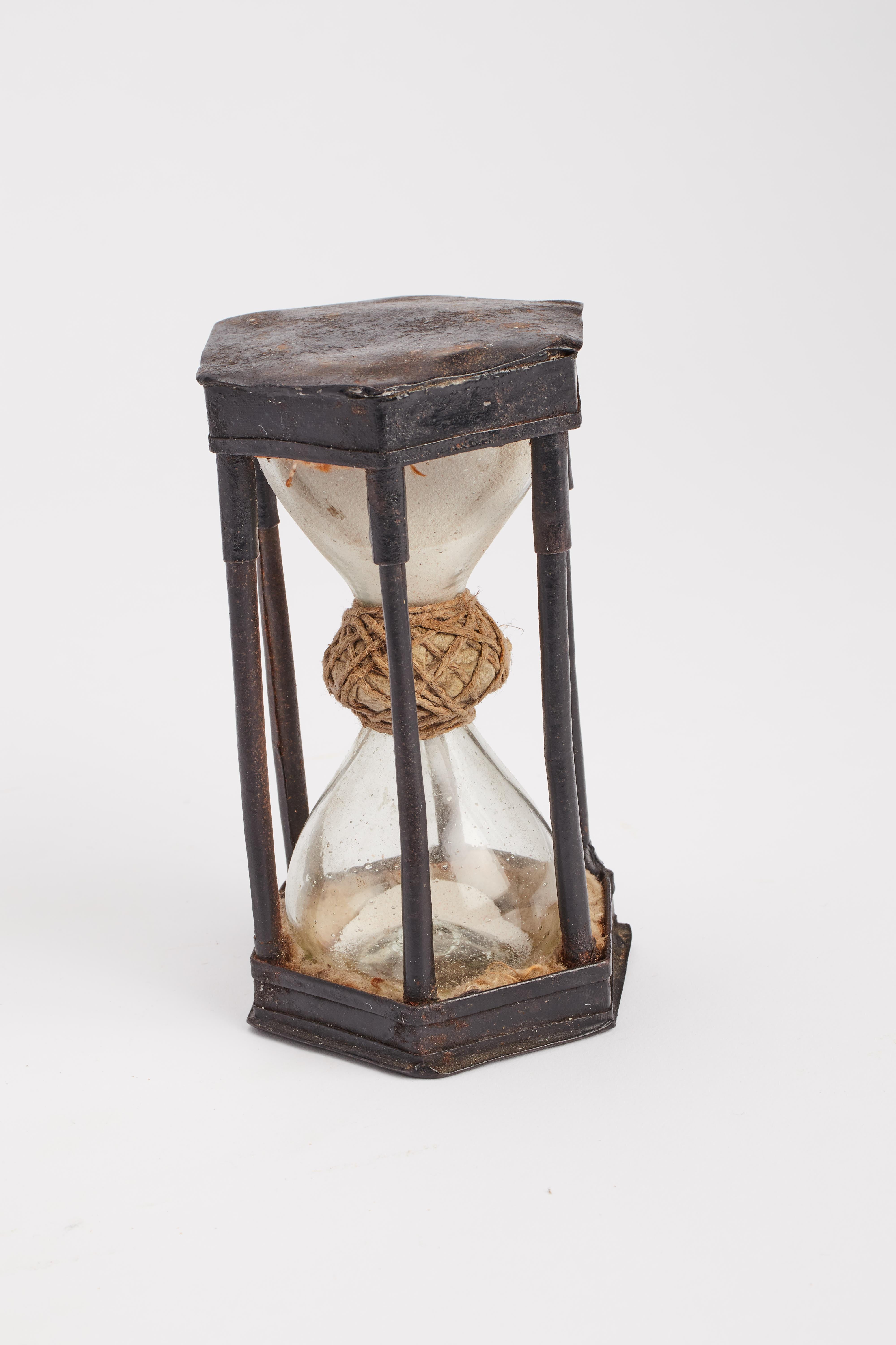 The hourglass cage displays hexagonal bases. Six smooth iron columns complete the cage. Inside the glass bulbs joined in the center by a ring of fabric and rope. Germany, early 1700s.