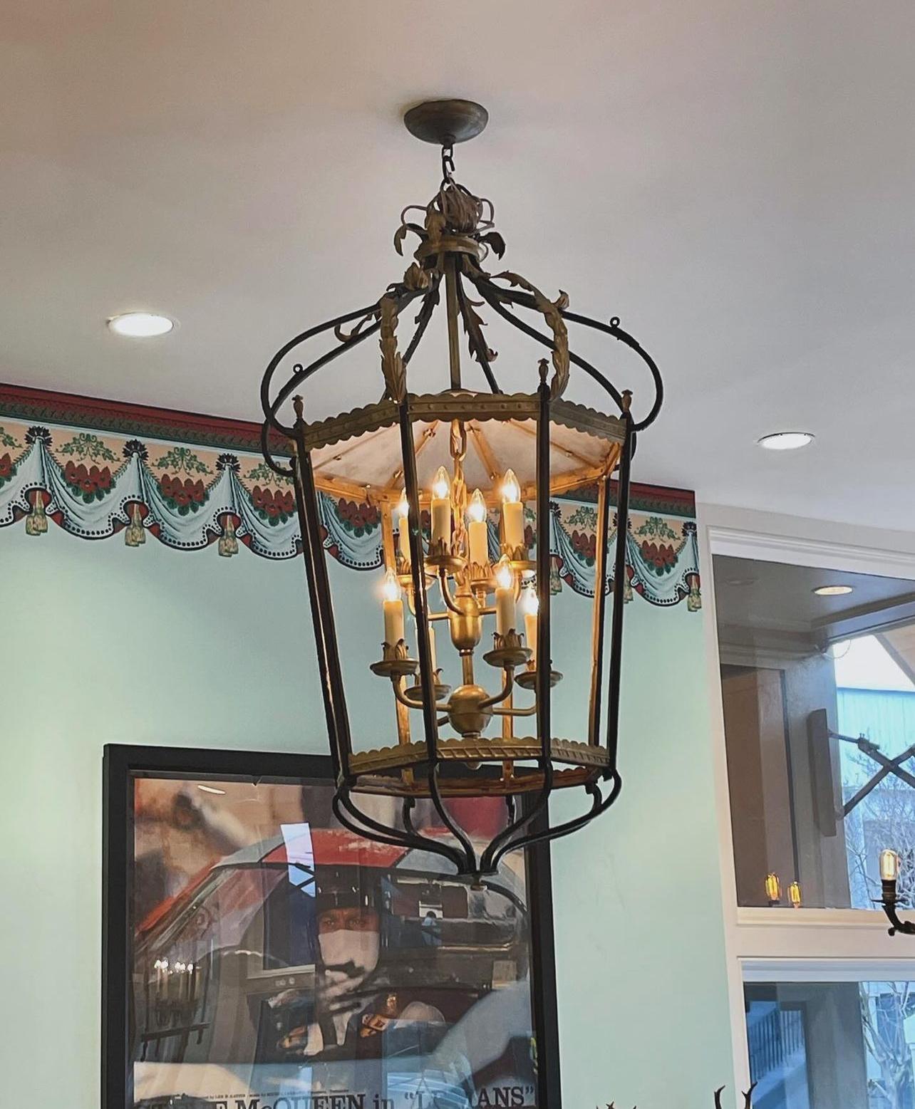 Large scale iron lantern with multiple tier inner light. Glass top. Painted with gold accents