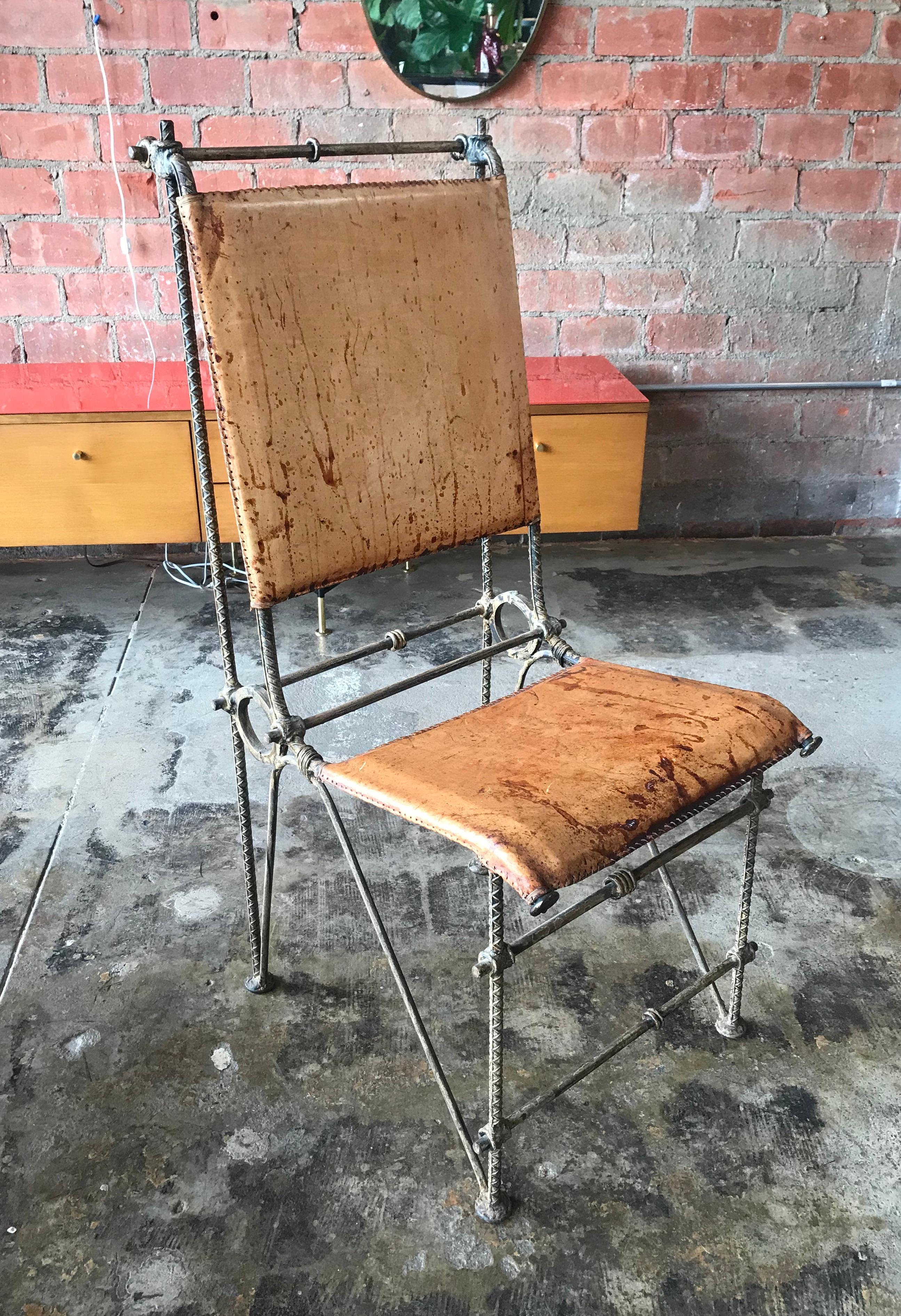 Very reminiscent of Brutalist designed furniture expression.
High quality Mid 20th century iron dining chair with distressed leather seats and backs attributed to Ilana Goor.
The chairs have a great old world / mid century modern design with