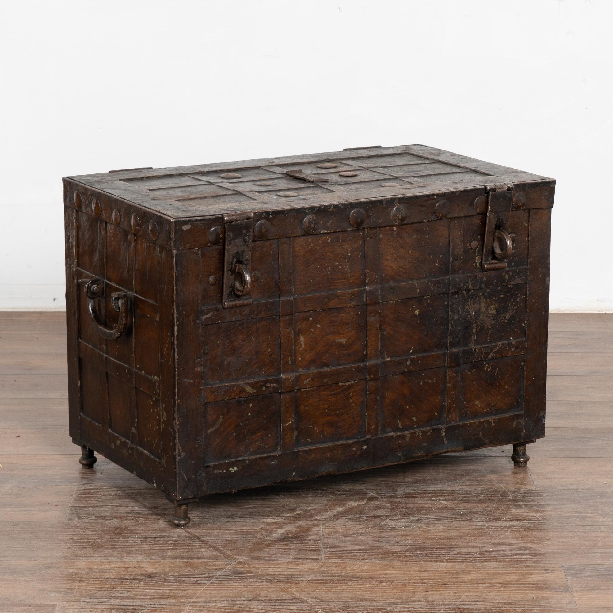This iron lock box is loaded with character from the  heavy iron handles, rivets and iron straps throughout.
There are two hinged latches allowing for additional padlocks to be added.
The exterior is painted a brown faux wood, and contrasting