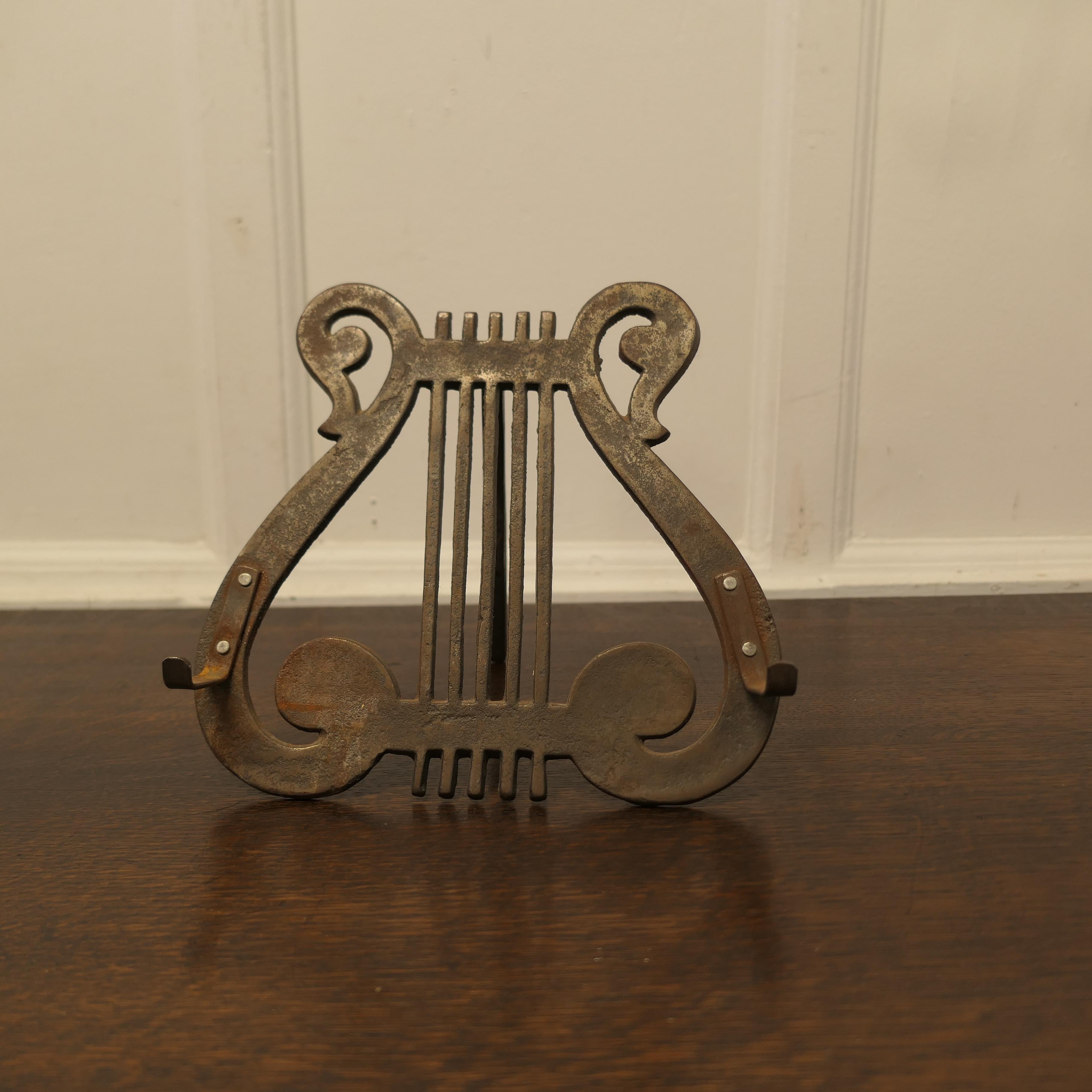 Iron Lyre Music Stand or Book Rest

This is a charming piece, it is made in solid iron and dates from the end of the 19th Century 
 
A charming piece and in good rustic condition and a  great book stand  

The stand is 18” deep, 11” wide and 10”
