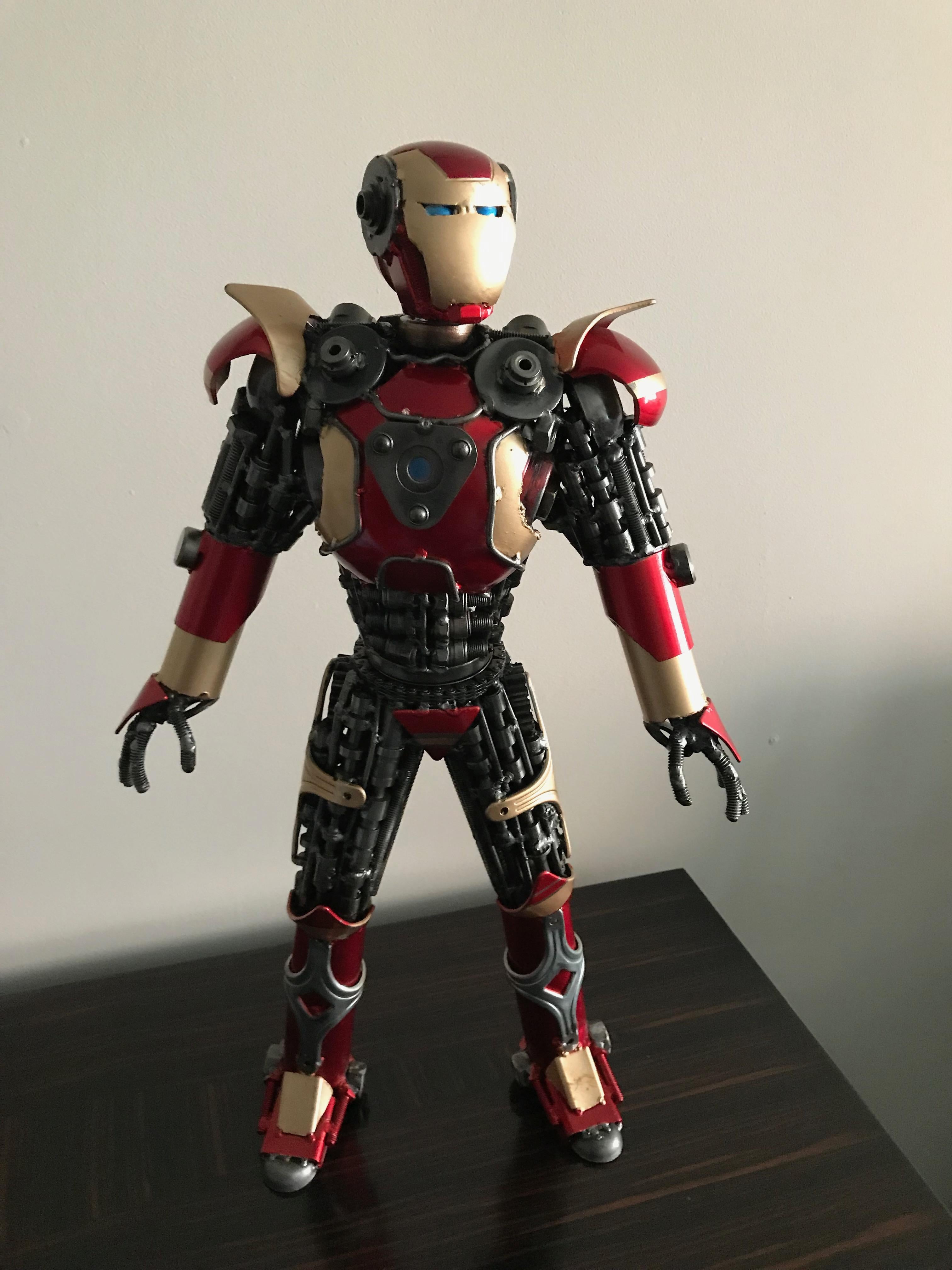 Iron Man metal sculpture made up of scrap metal parts. Standing at 22 inches. The middle section of the body can rotate along with his head. Amazing details. Perfect for any Marvel collectors.