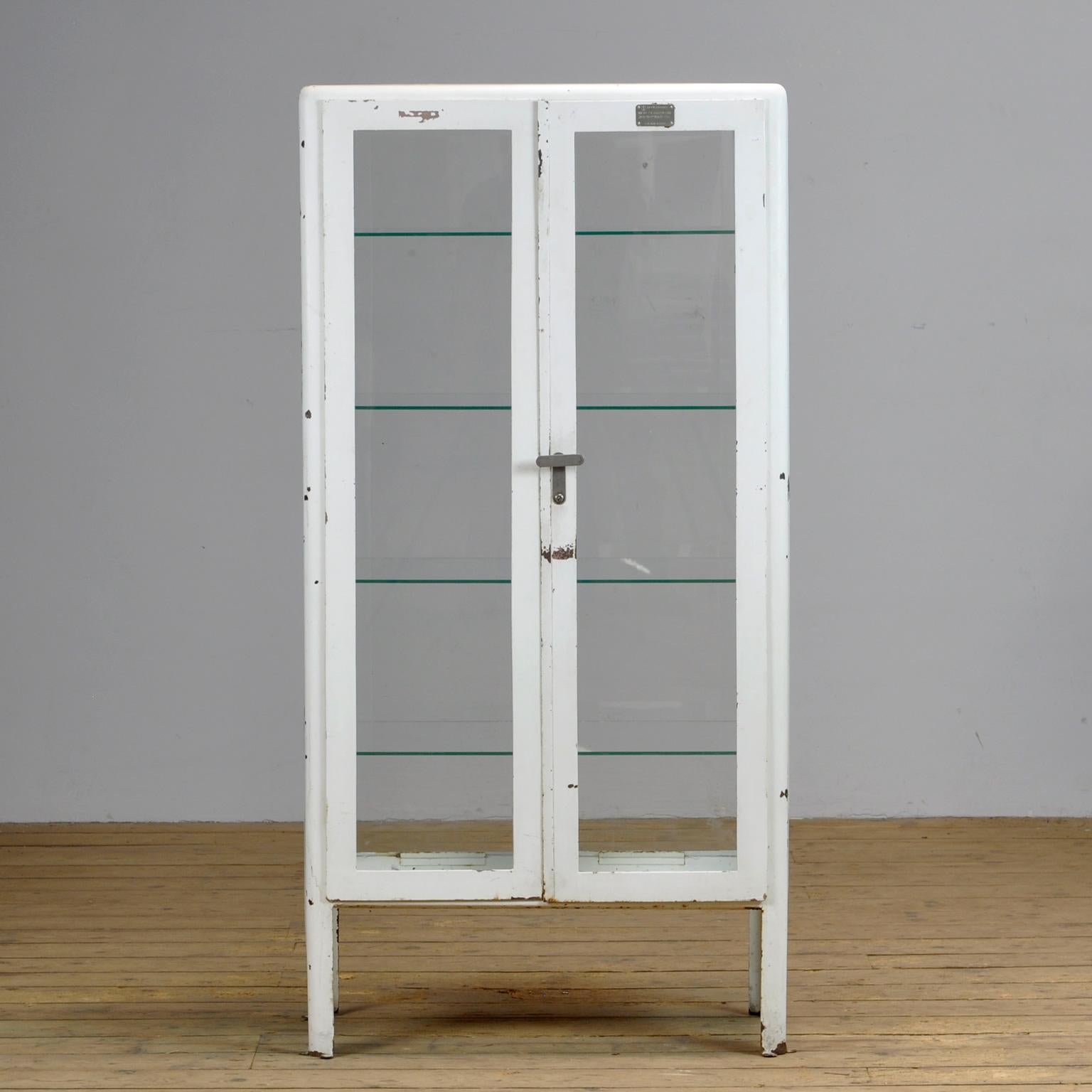 Iron medicine cabinet from the Ukraine with glass on four sides. Produced in the 1960's. Space between the shelves is 28 cm.