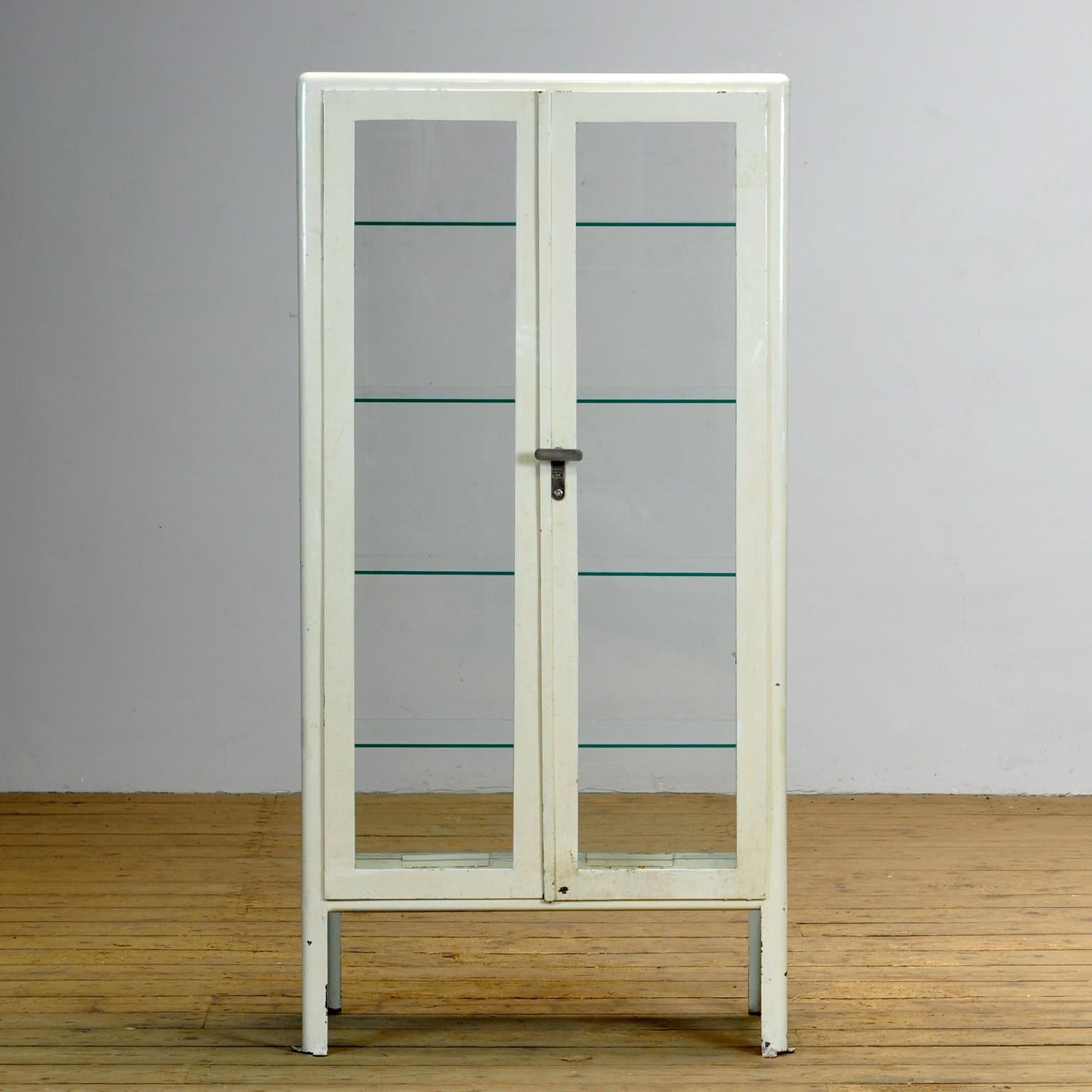 Iron medical cabinet from the Ukraine with glass on four sides. Produced in 1970. Space between the shelves is 28 cm.