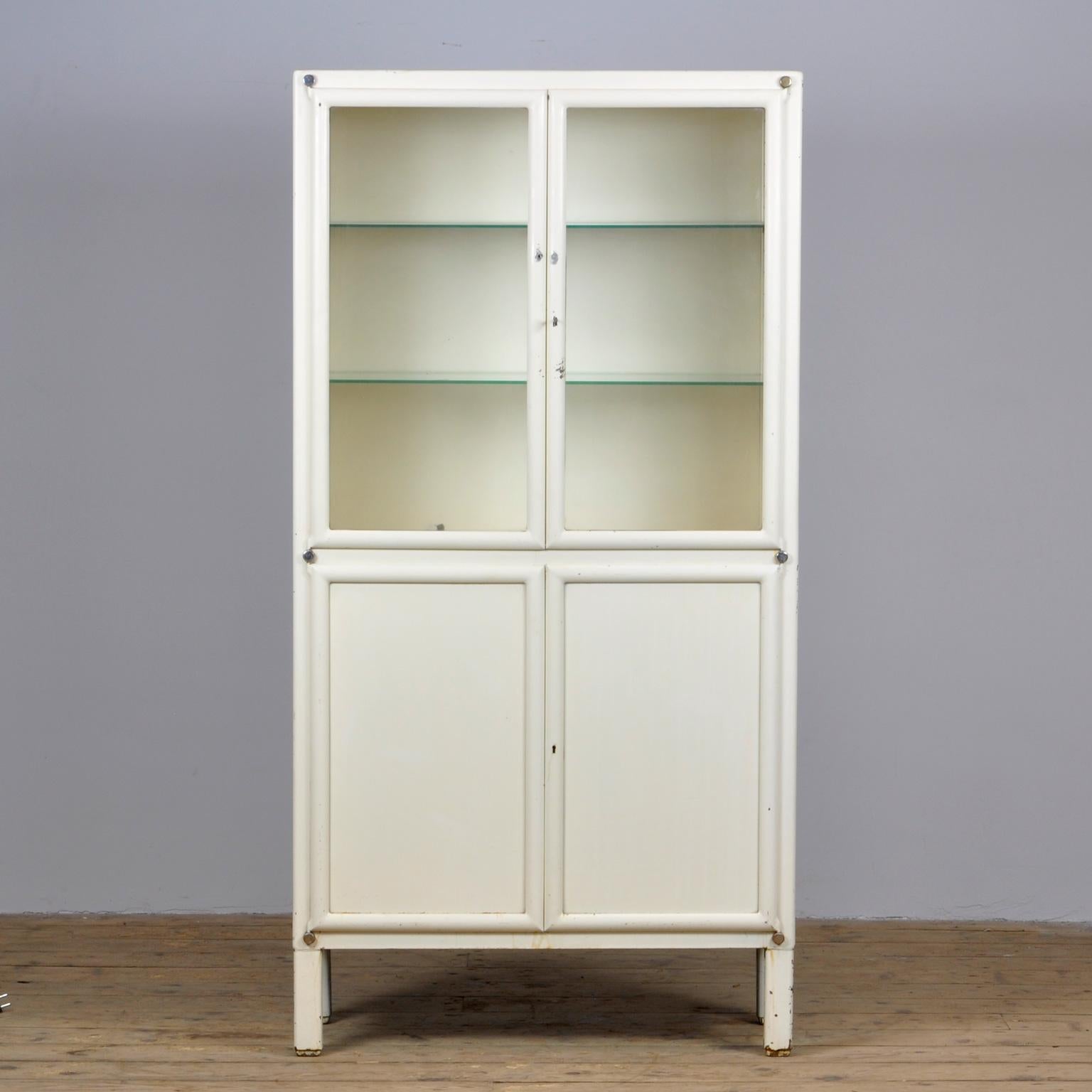 Medical cabinet from Czechoslovakia, produced by Kovona, circa 1950. With two adjustable shelves in the top part and one shelf in the lower part Original paint and locks.