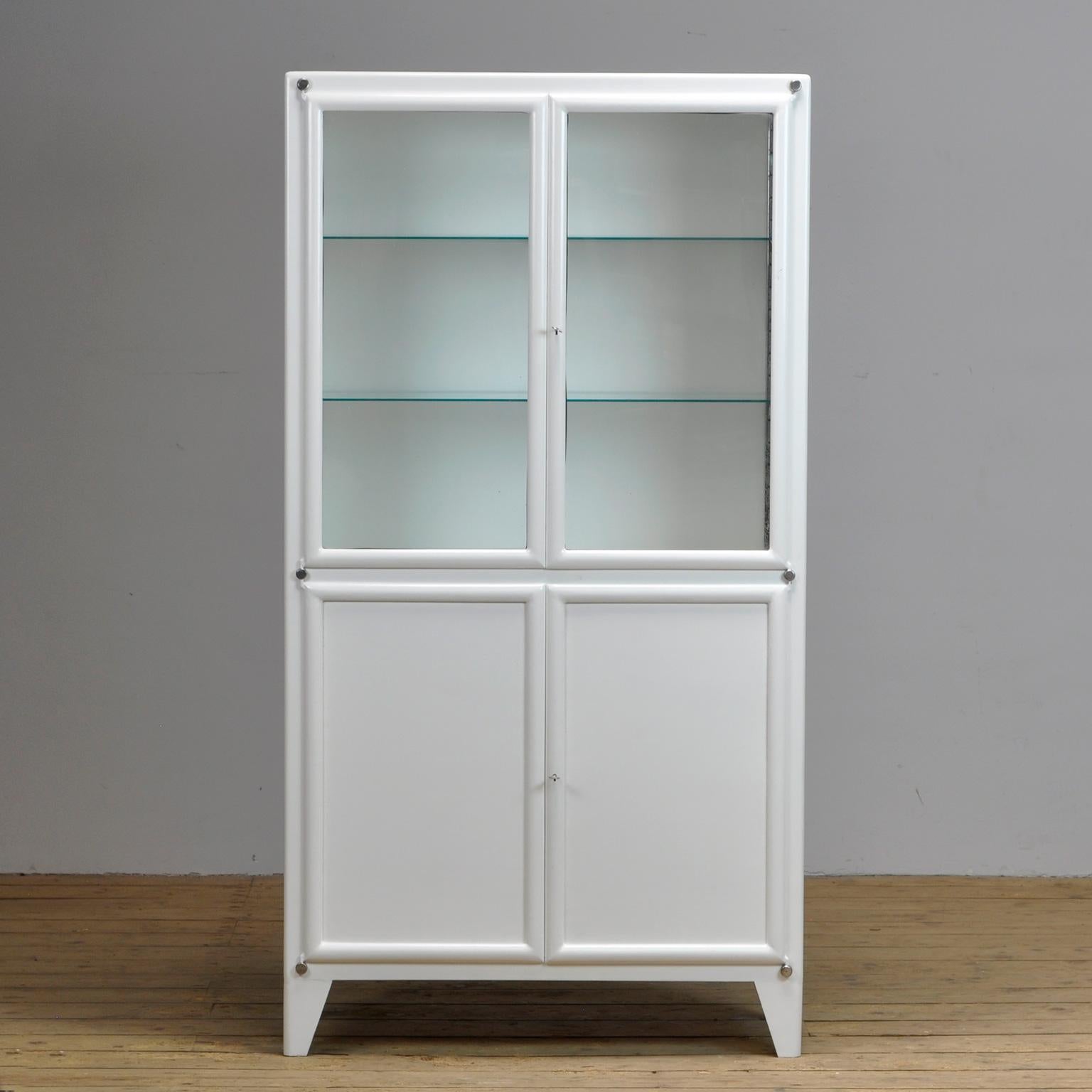 Medical cabinet from Czechoslovakia, produced by Kovona, circa 1950. With two adjustable shelves in the top part and one shelf in the lower part Original paint and locks.
    